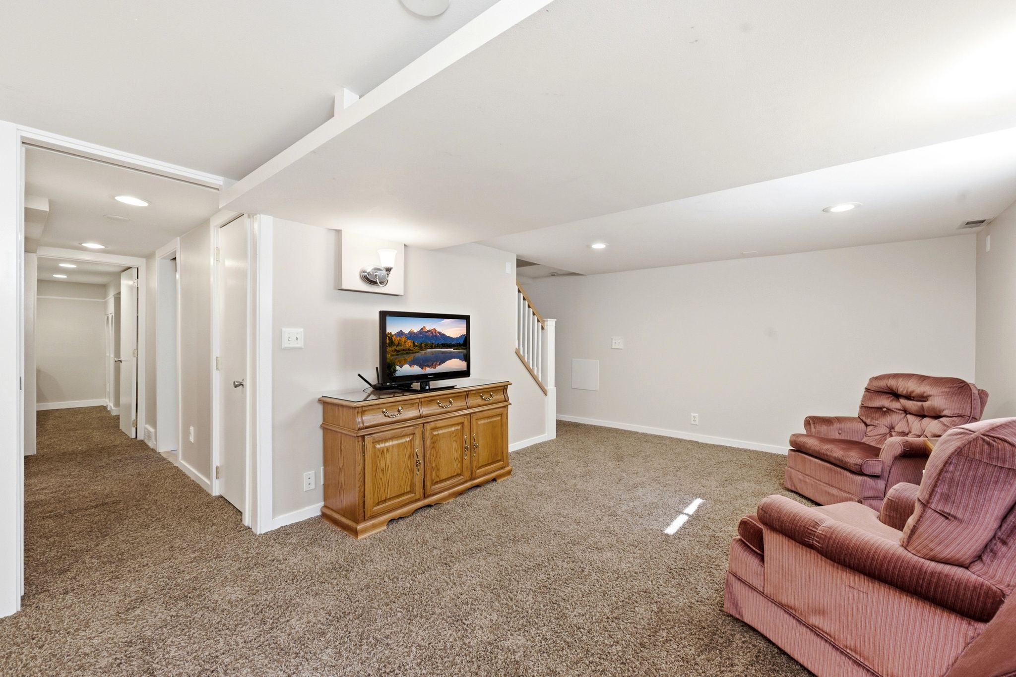 Carpeted entertainment area featuring recessed lighting, light gray wall paint, and white trim