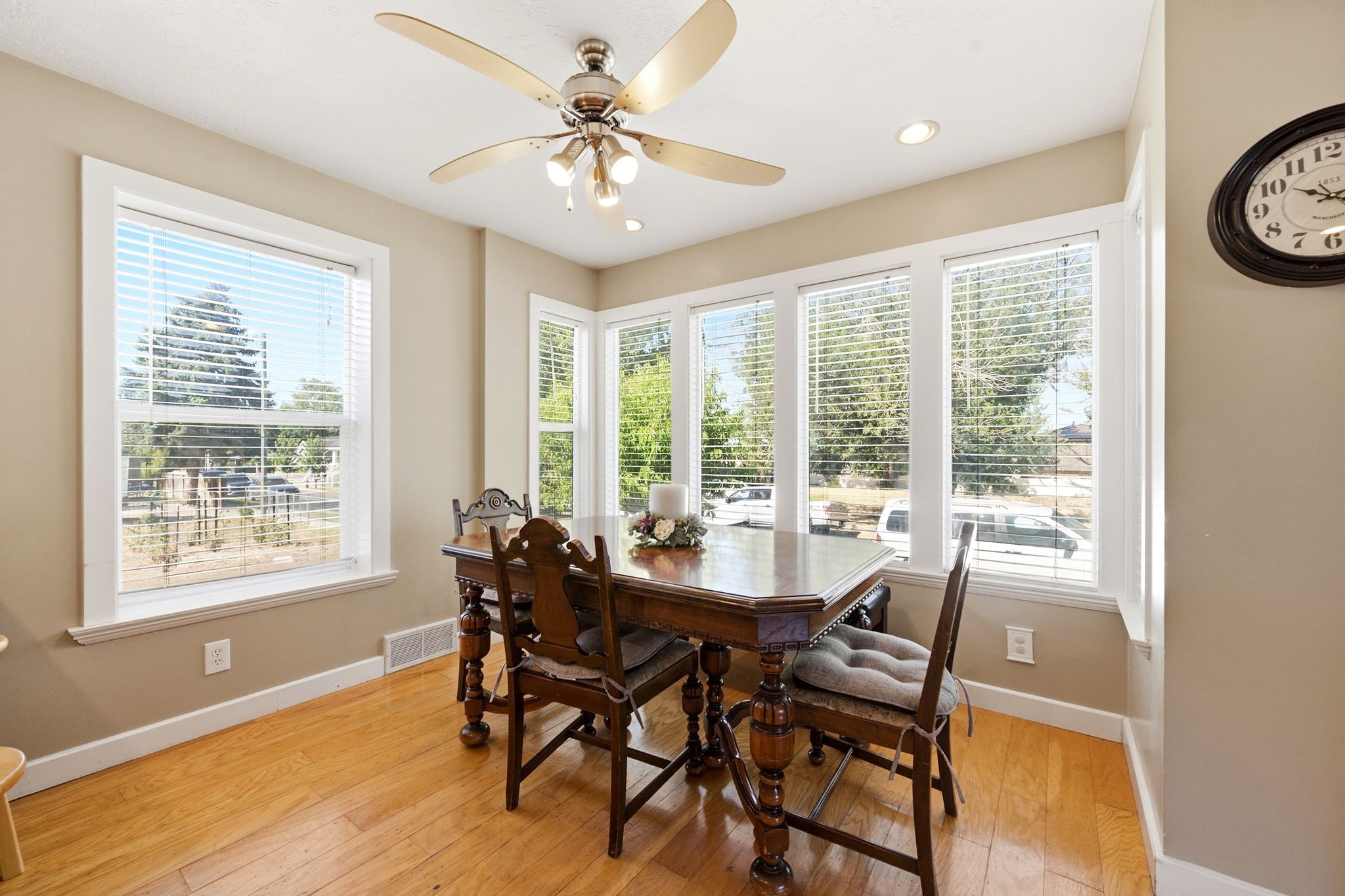 Dining area featuring light wood-finish flooring, neutral wall tones, and white trim