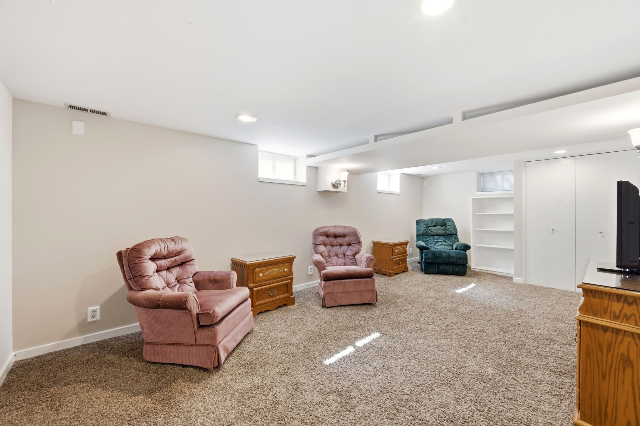 Carpeted recreation room featuring neutral painted walls, recessed lighting, and high ceilings