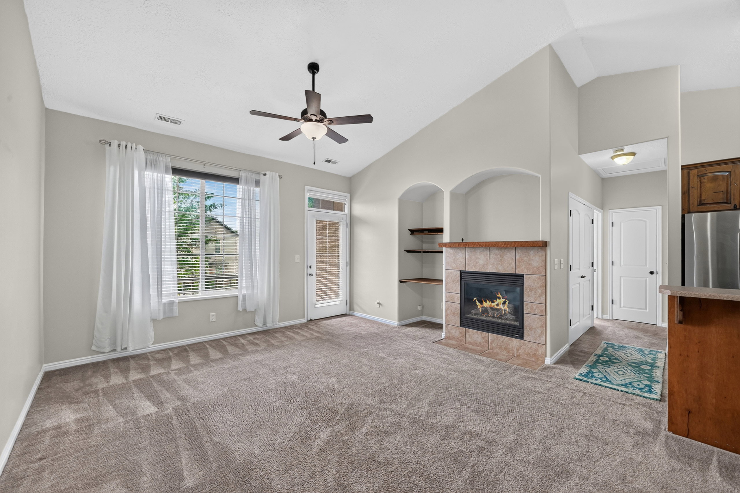 Living area featuring a gas fireplace with a tiled surround and wood mantel