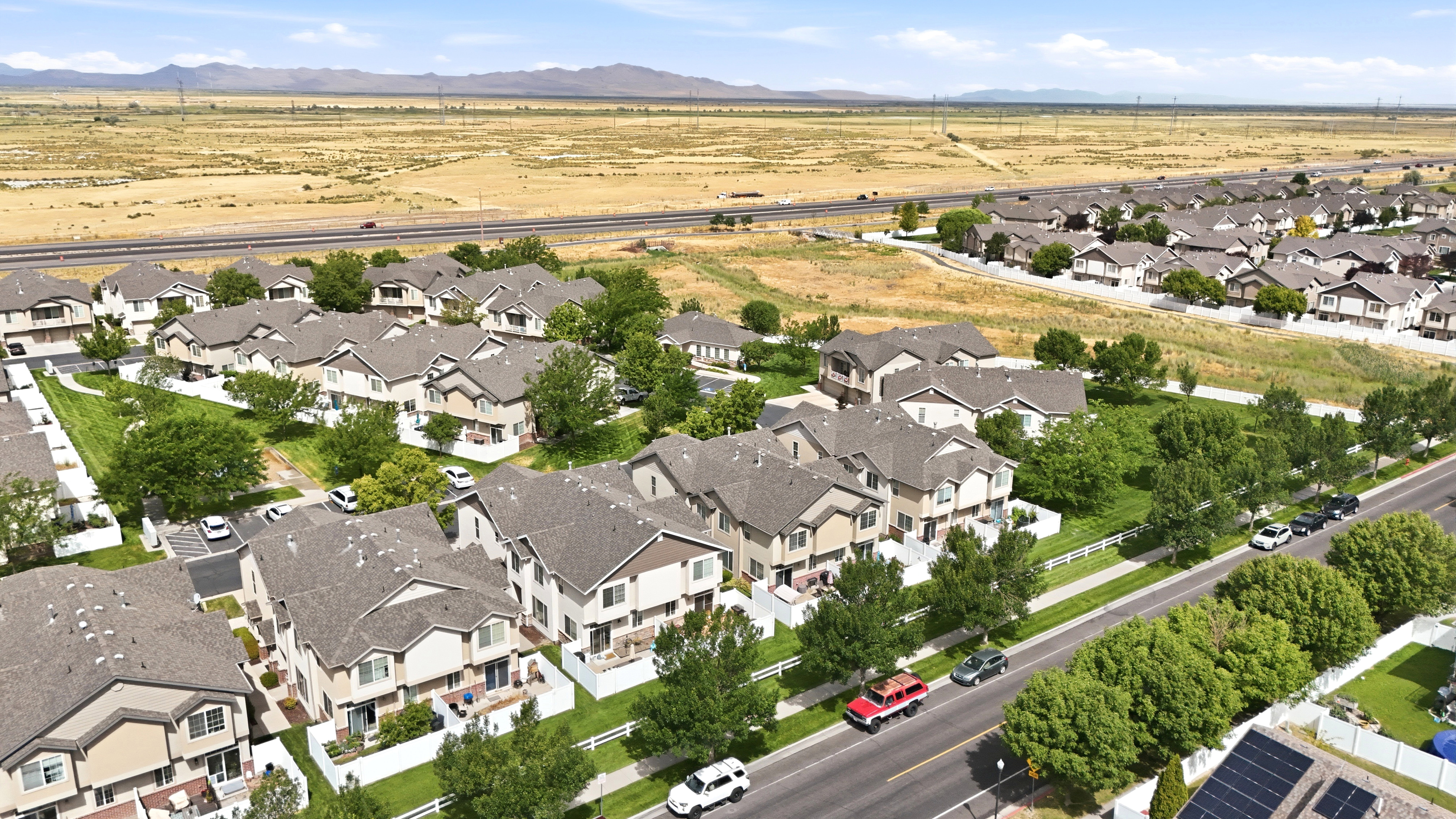 Aerial perspective showcasing a residential community with uniform townhomes
