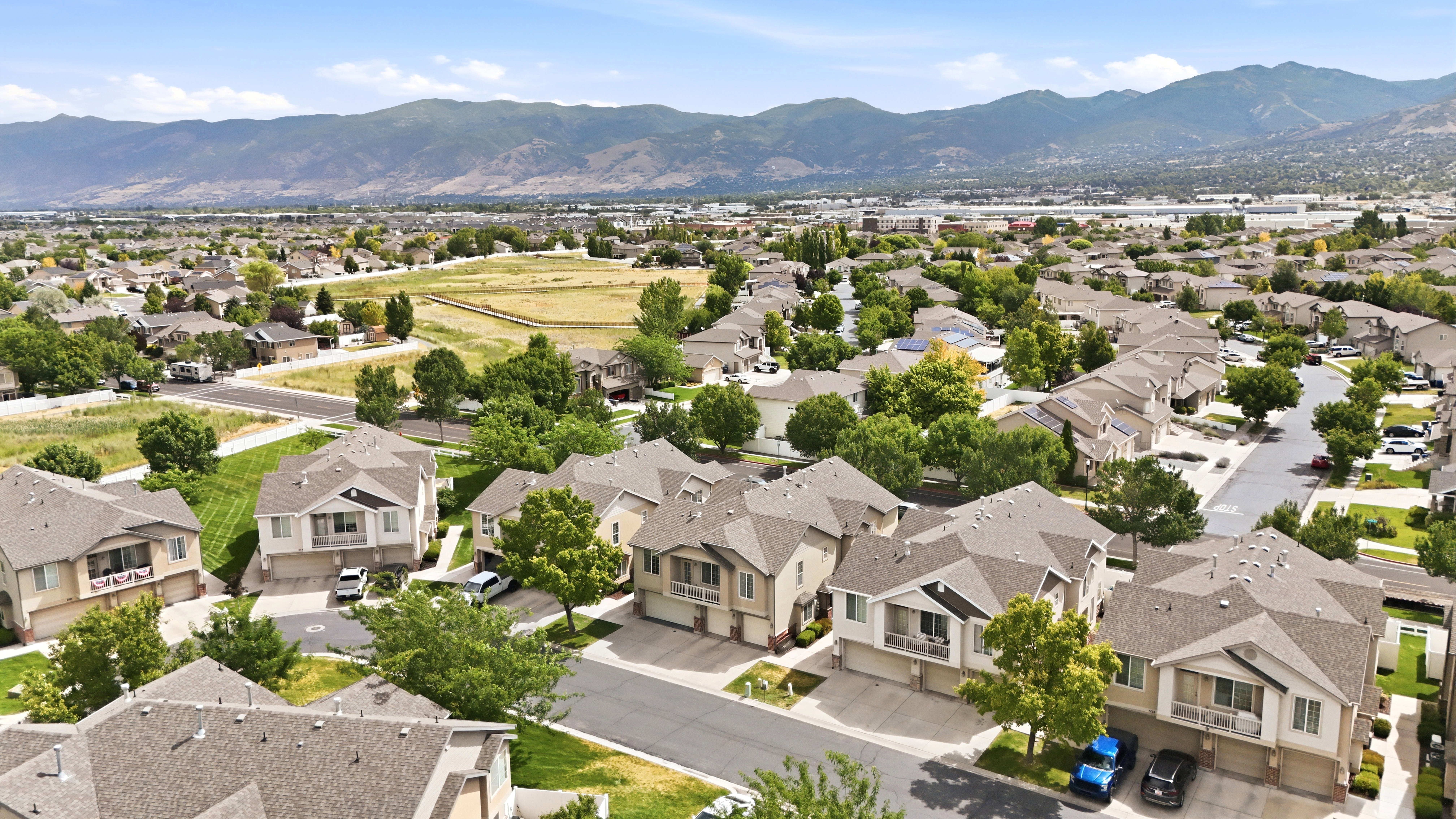 Expansive suburban community featuring multiple residential streets, mature landscaping, and mountain backdrop