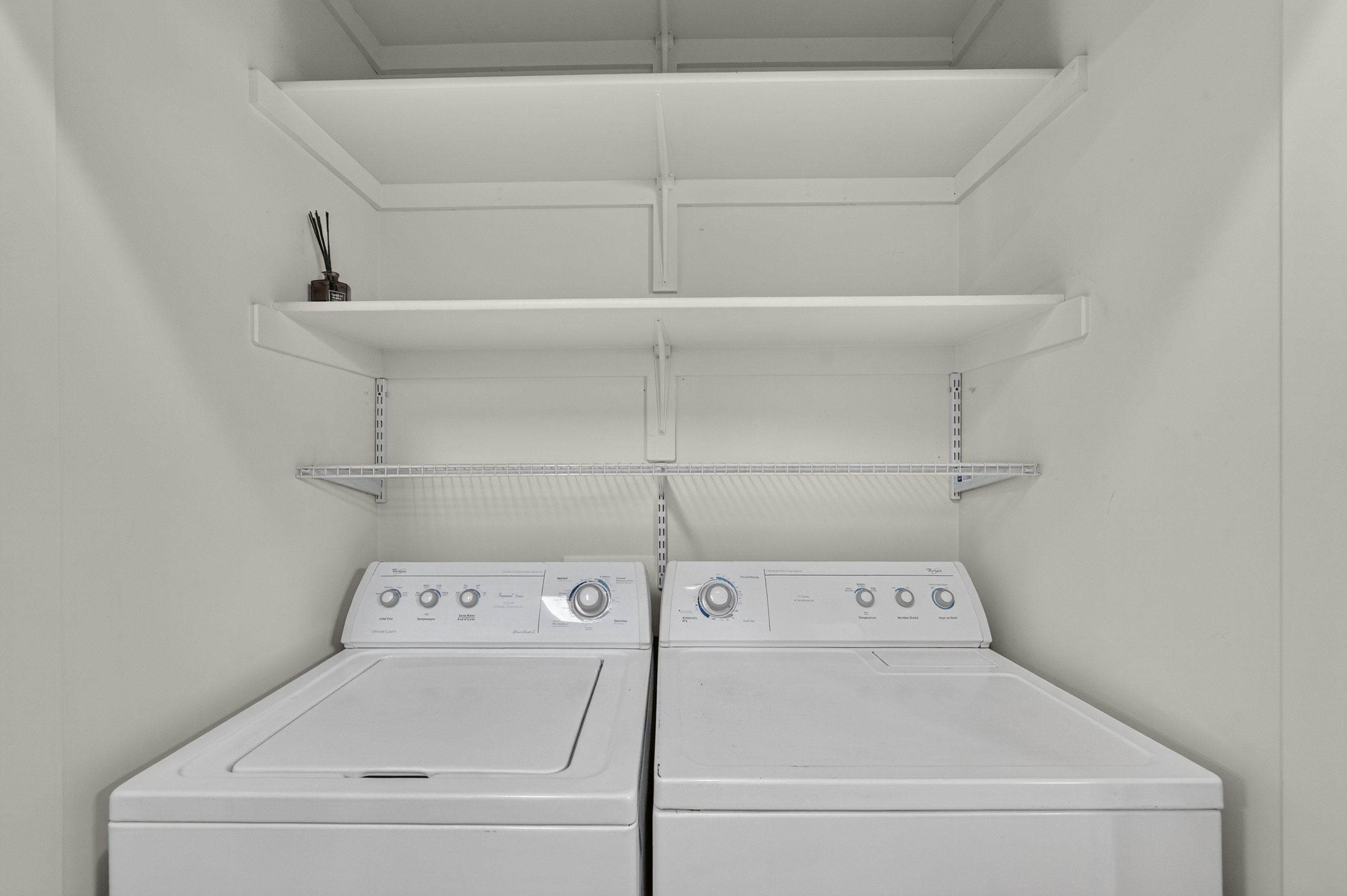 Dedicated laundry area featuring white appliances