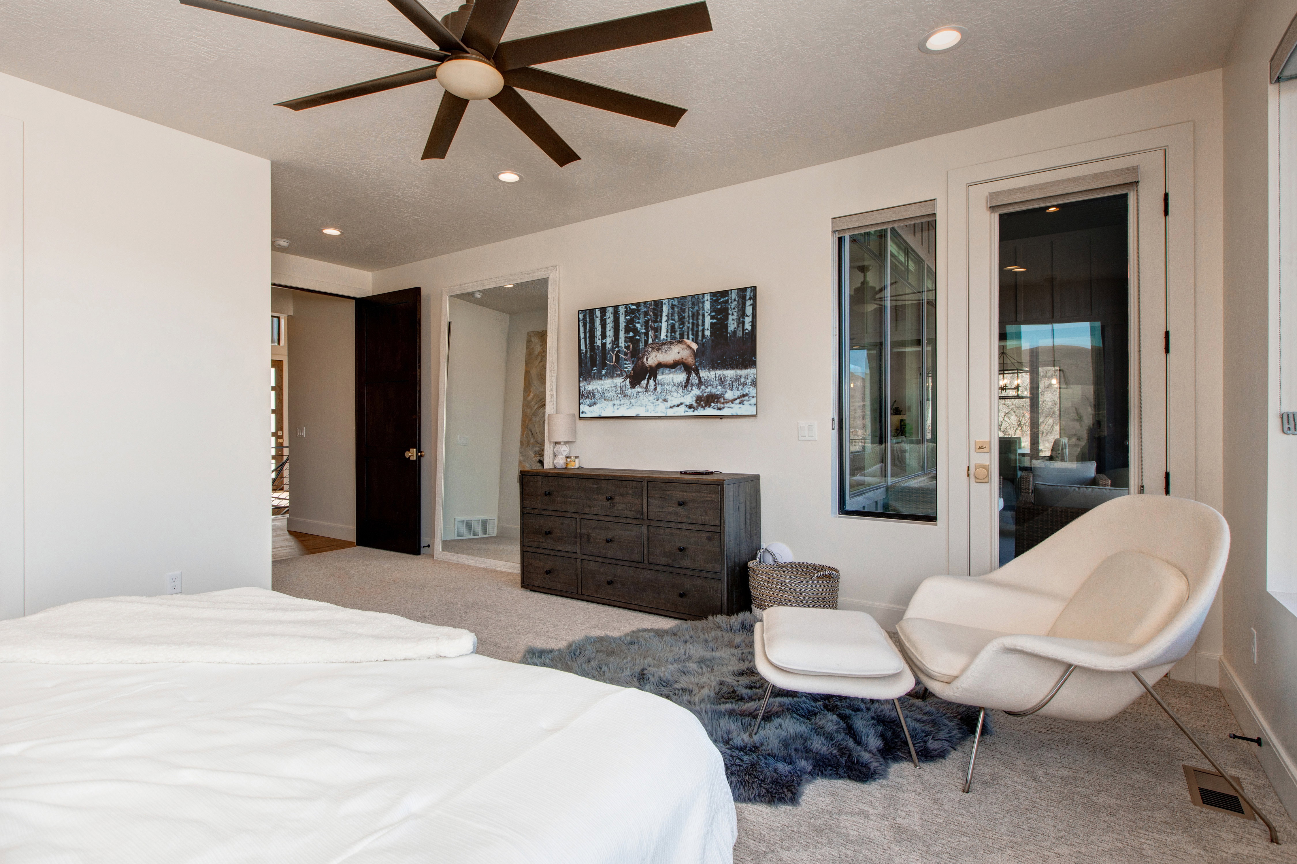 Bedroom featuring a contemporary ceiling fan, recessed lighting, and a dark wood dresser