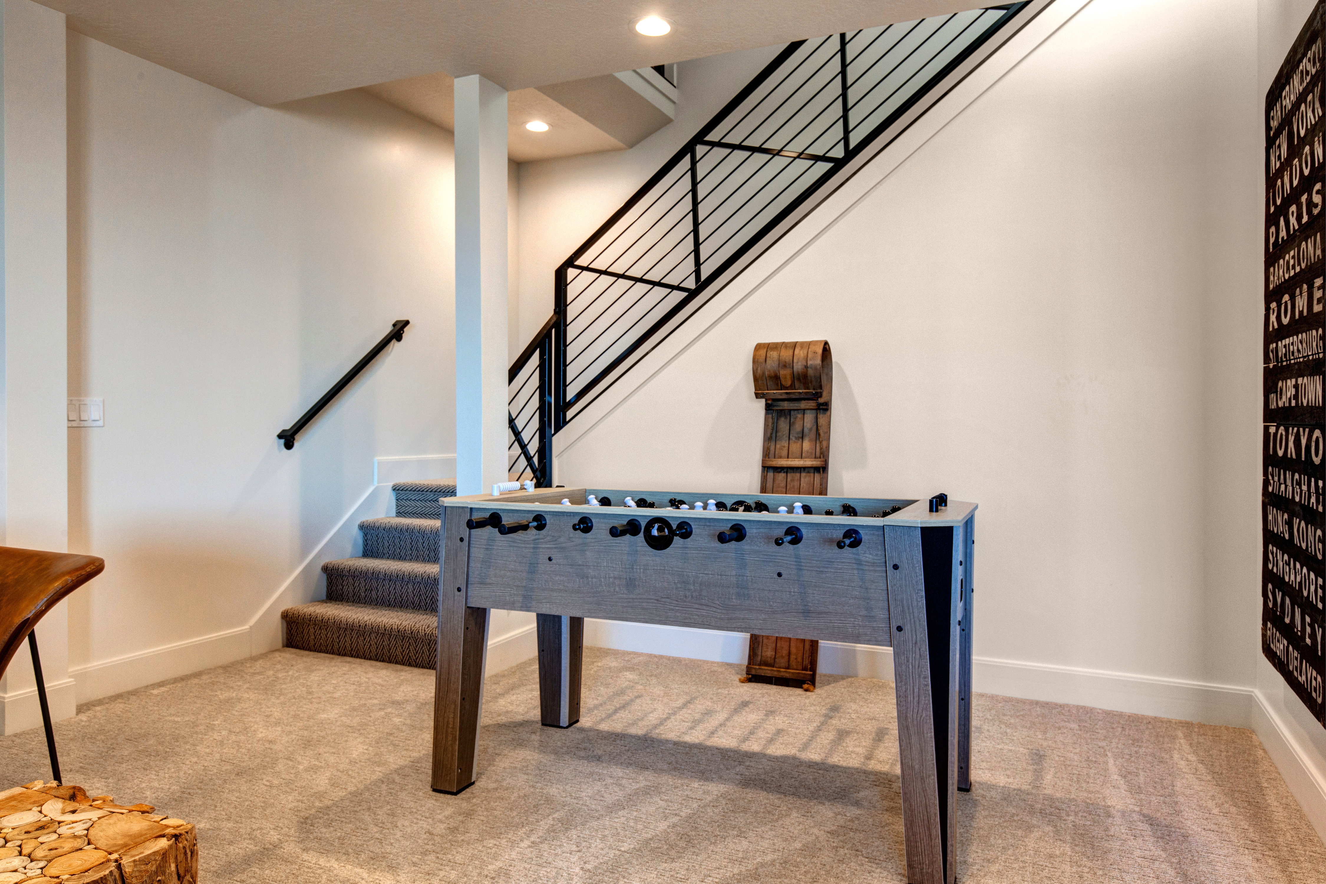 Carpeted staircase with contemporary black metal railing