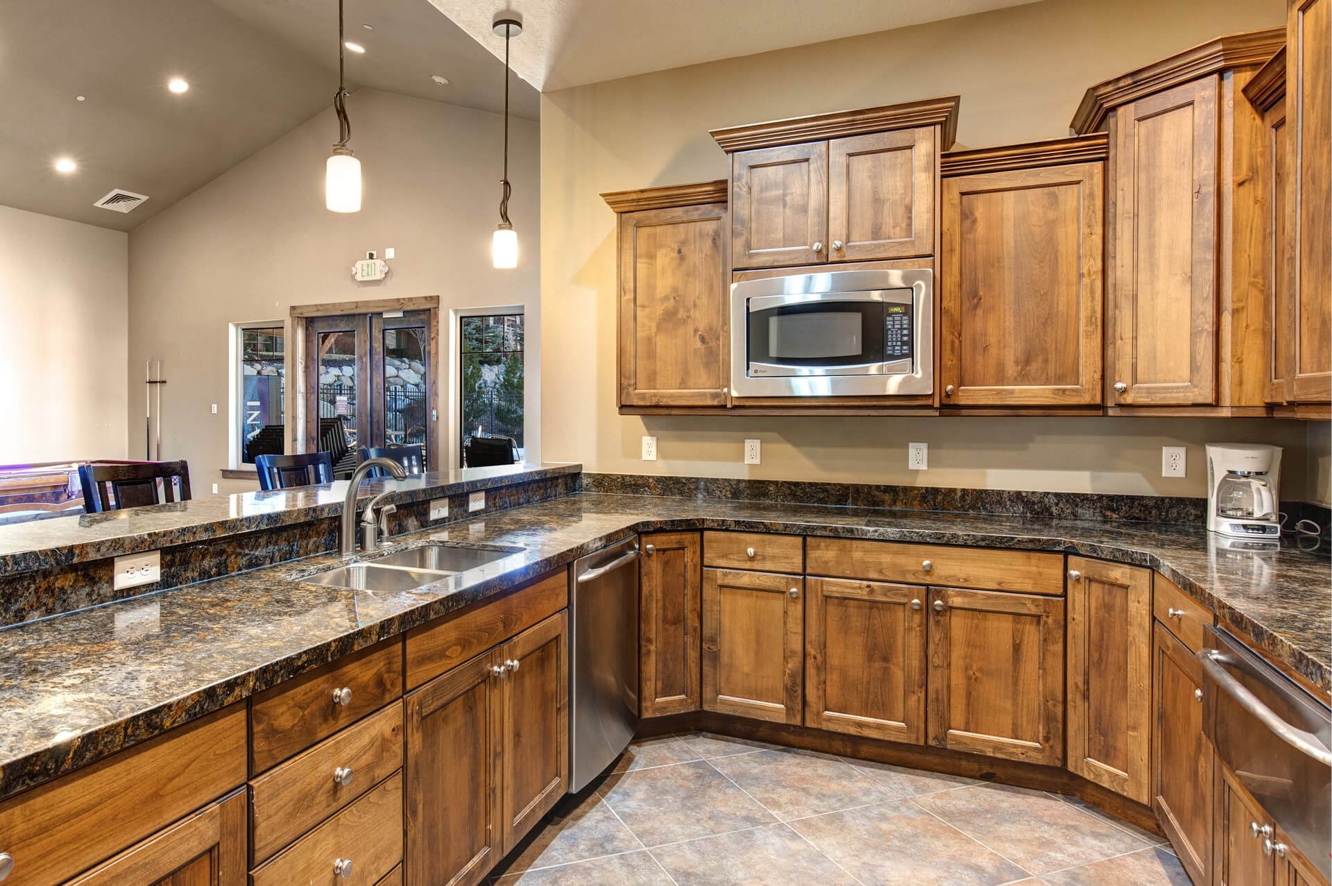 Kitchen featuring wood cabinetry, stainless steel appliances, and a double-basin sink