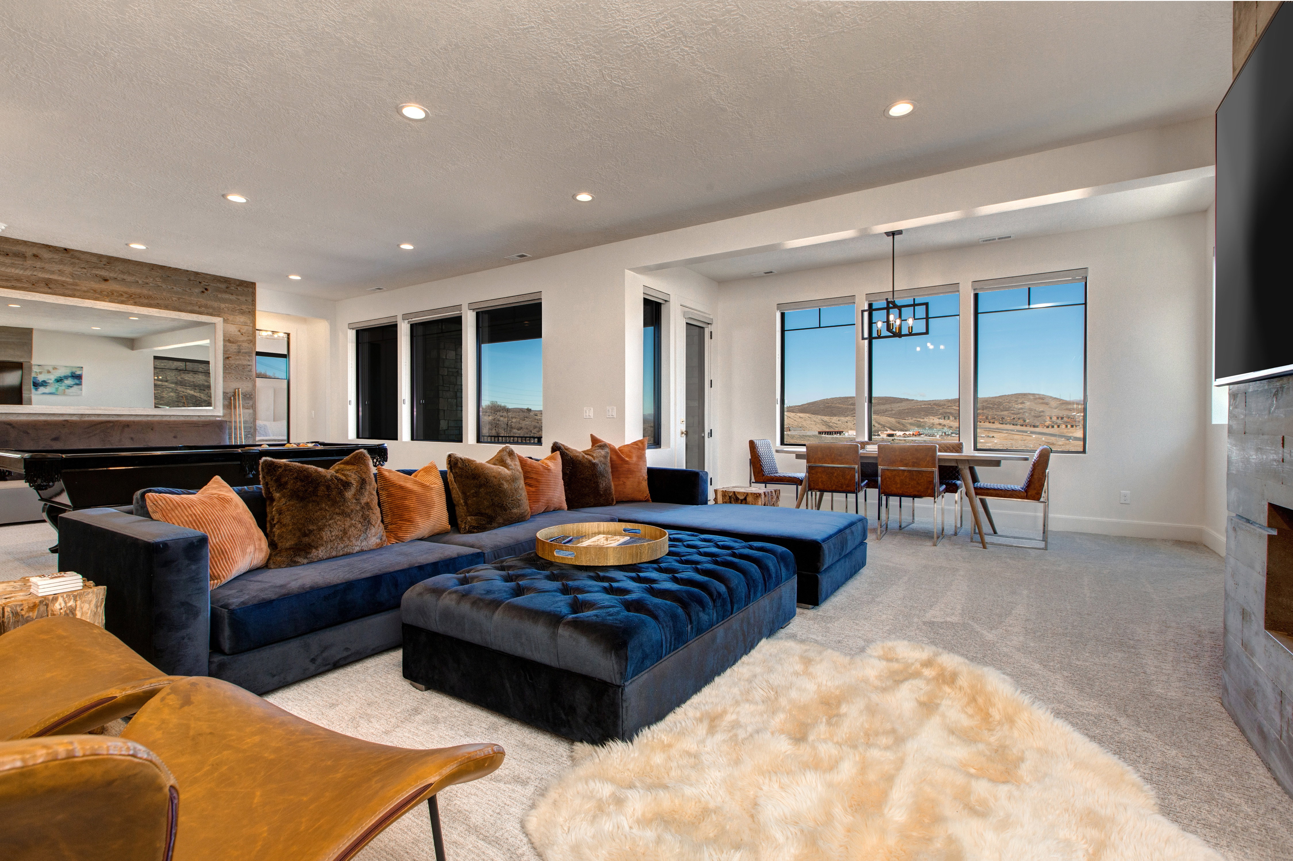 Spacious living area featuring recessed lighting and light-toned carpeting
