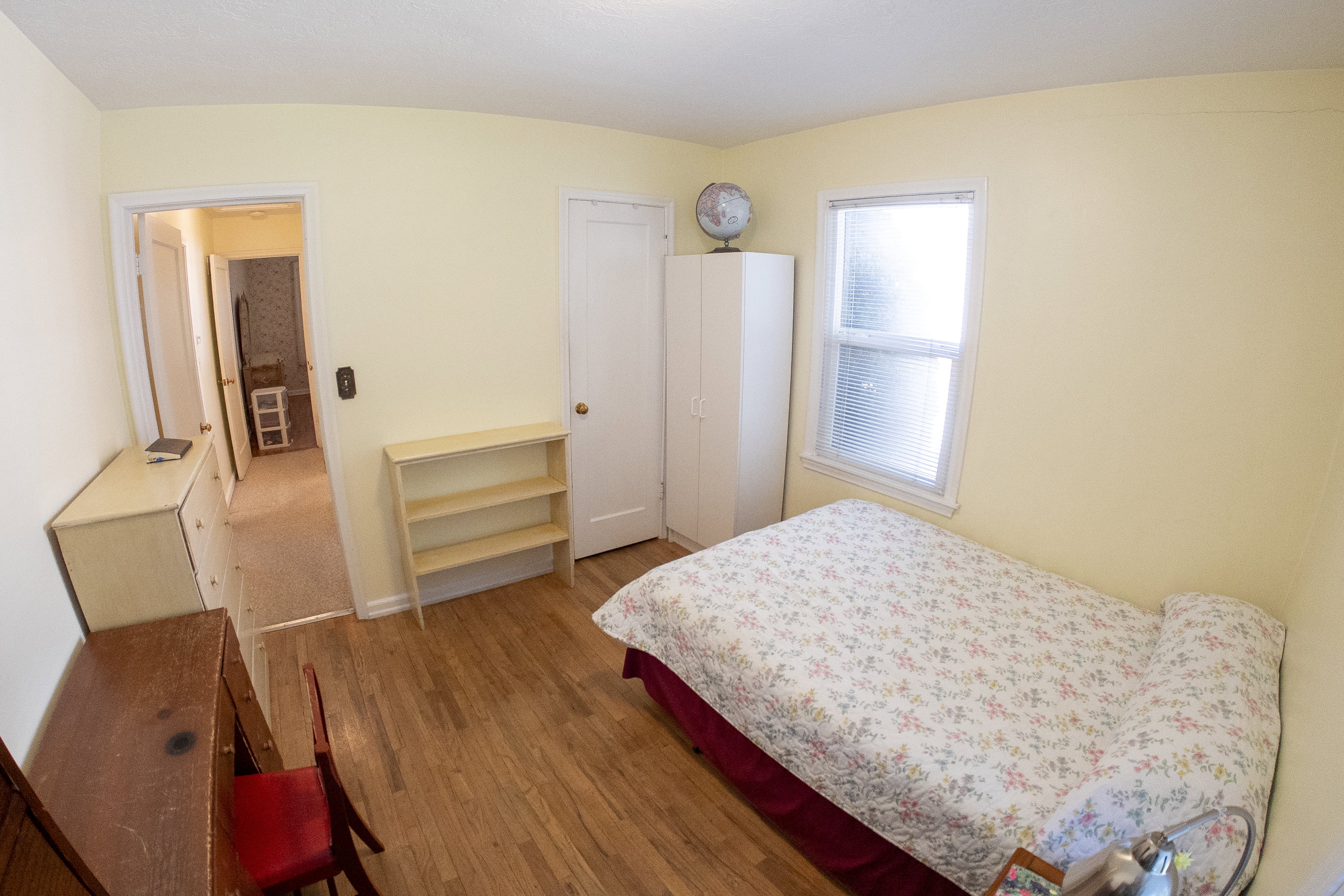 Hardwood flooring, light-toned walls, and a window with blinds