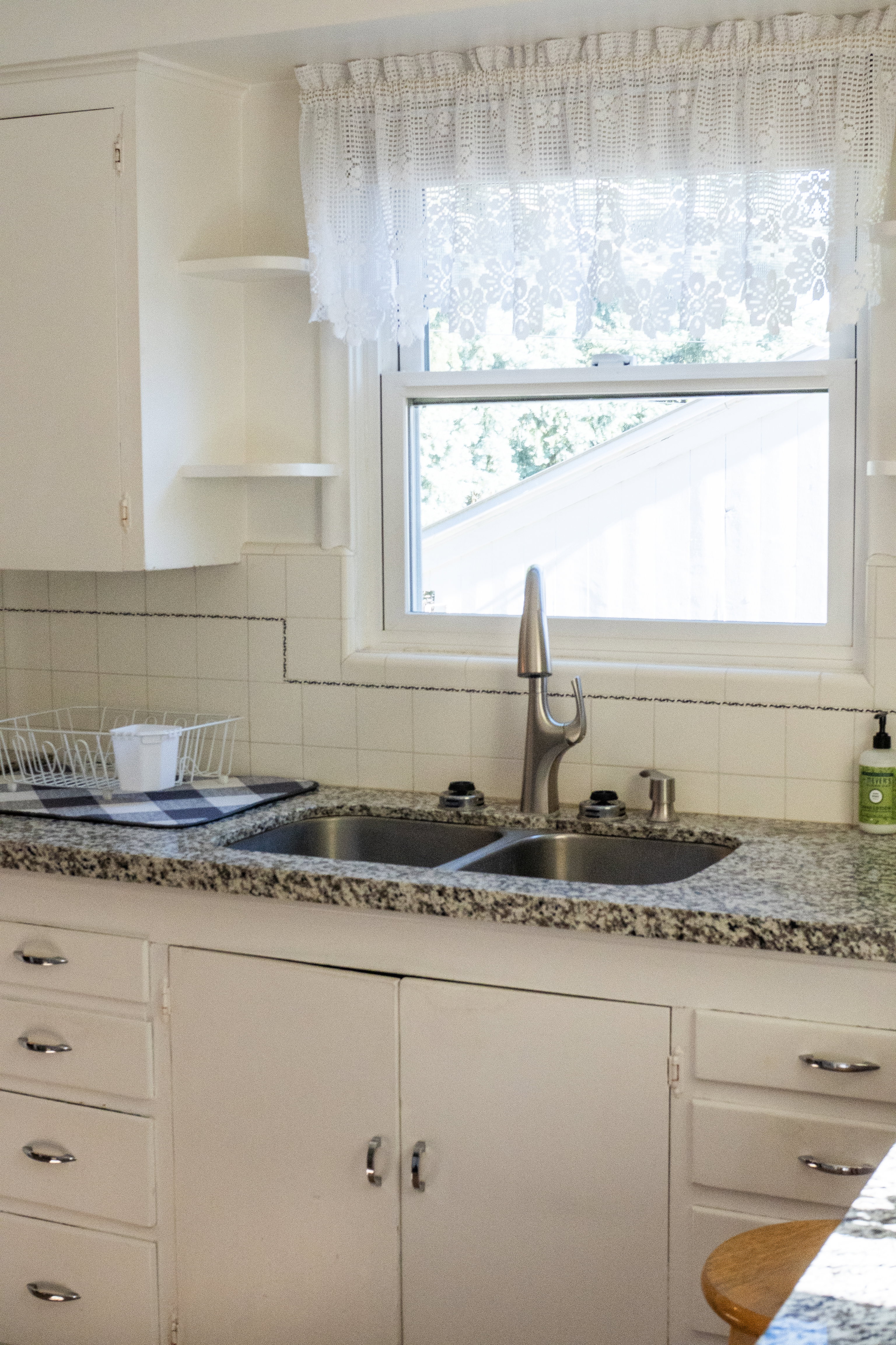 Double basin stainless steel sink with a modern gooseneck faucet