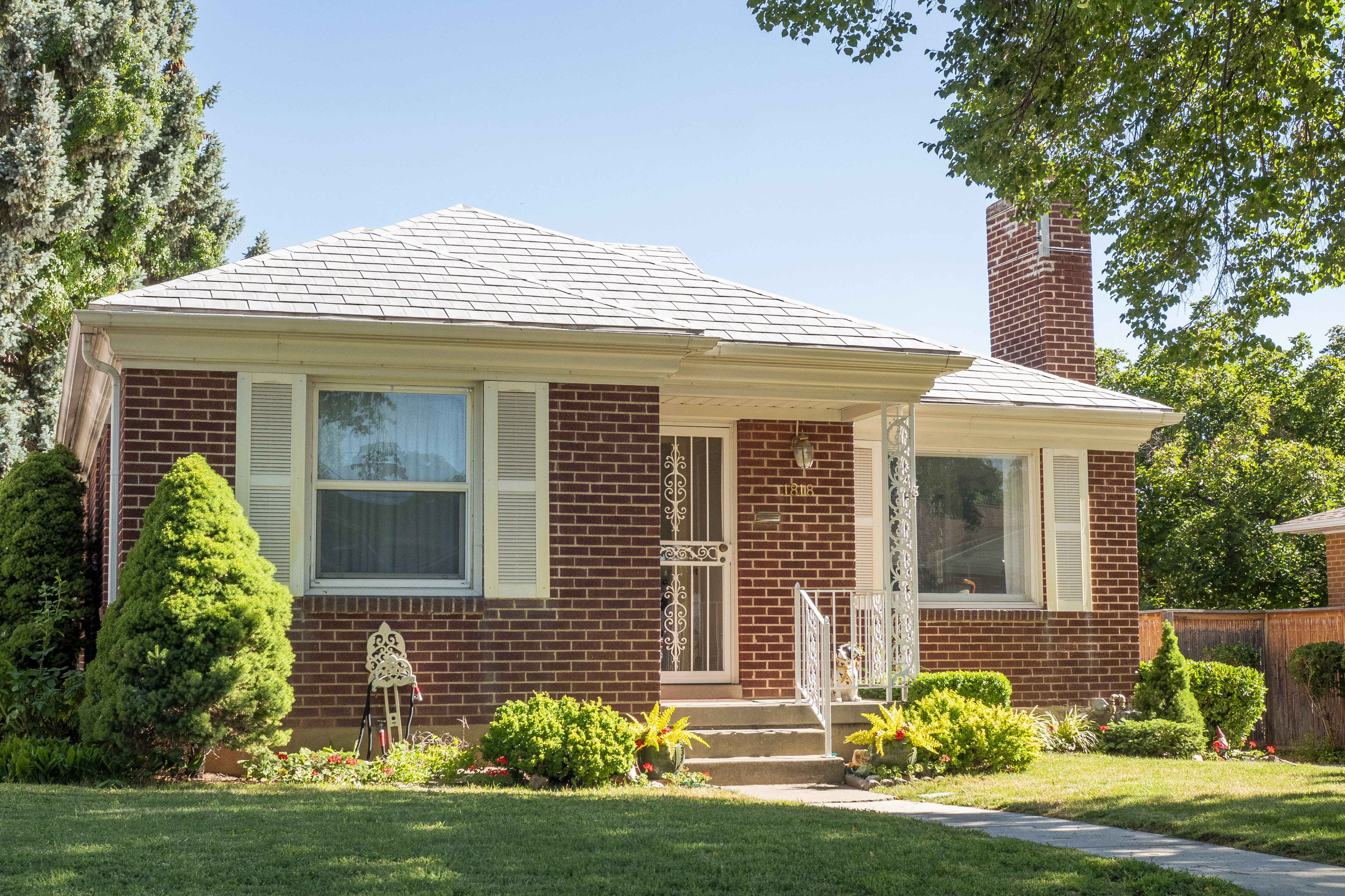 Red brick exterior with white trim and a gabled roof