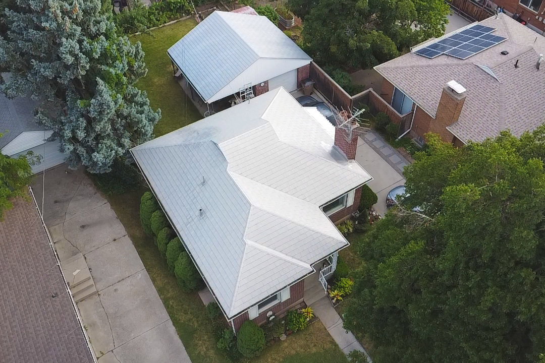 Traditional brick residence with a light-colored metal roof