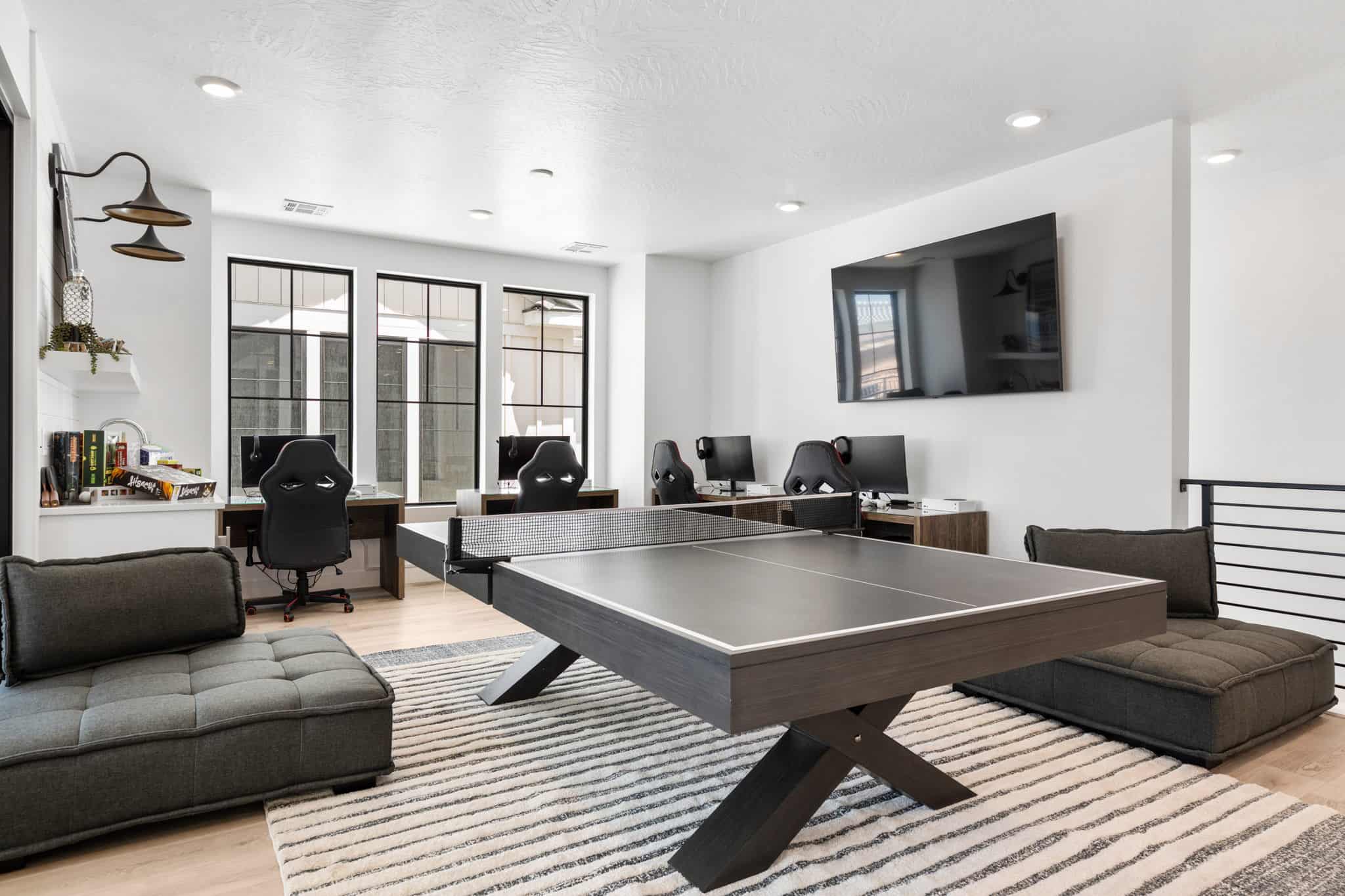 Spacious loft area featuring recessed lighting, light wood-finish flooring, and a contemporary railing system