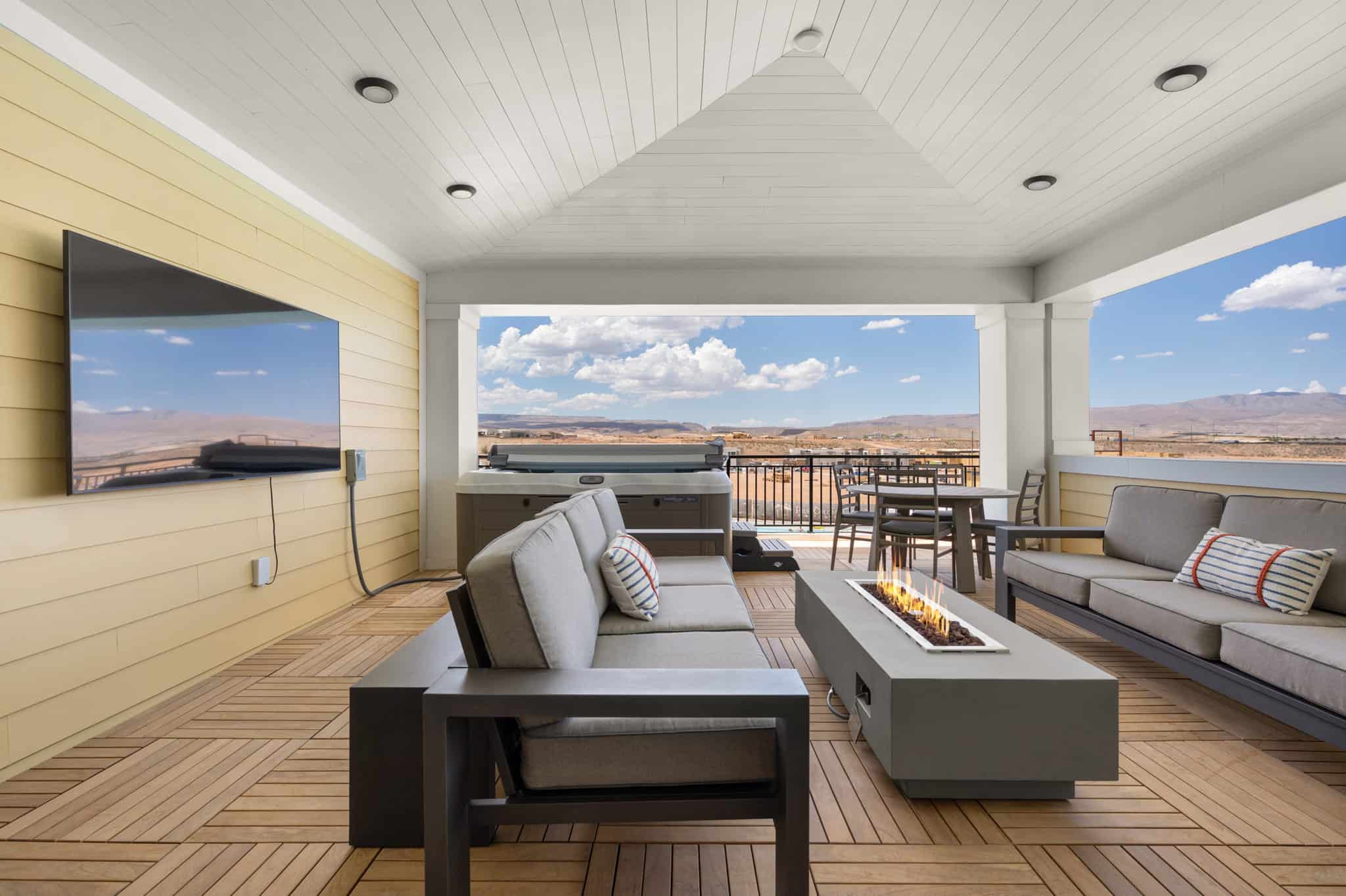 Covered outdoor patio featuring wood-finish flooring, a vaulted plank ceiling, recessed lighting, and a fire pit