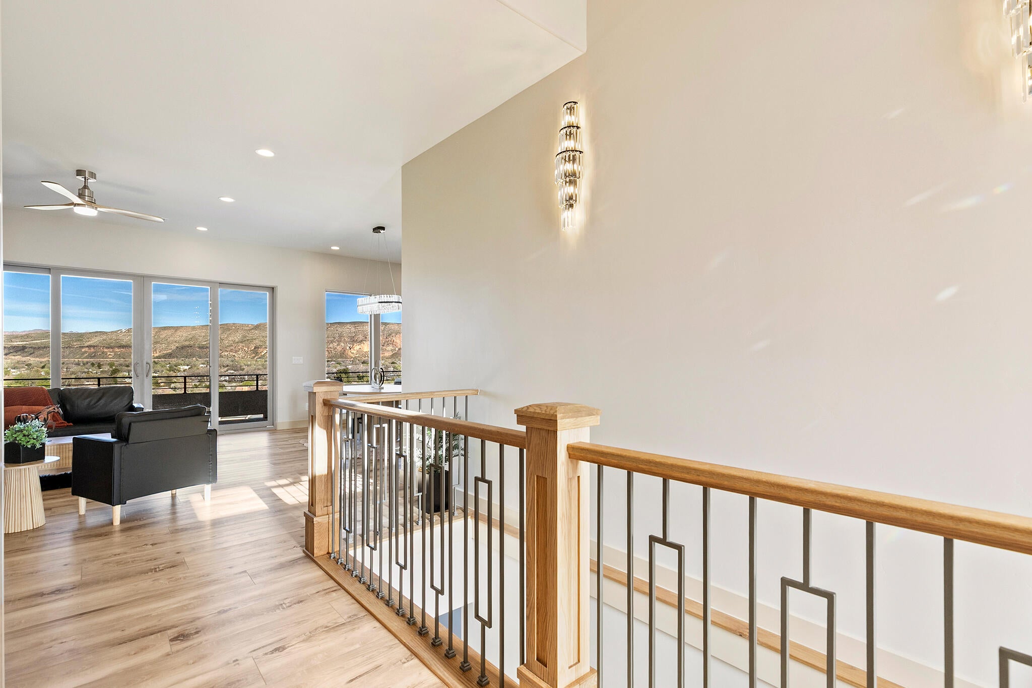 Upper-level landing featuring a wood and metal railing system