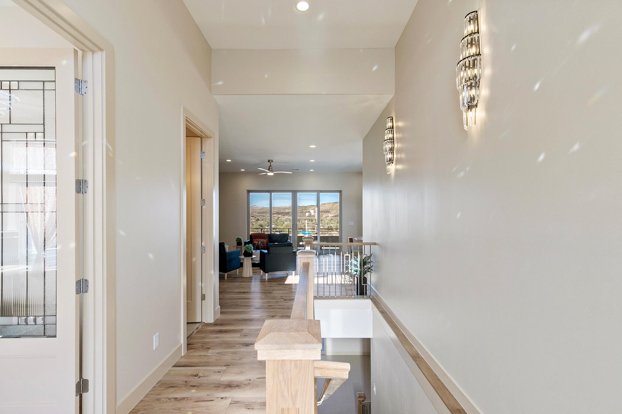 Hallway featuring wood-finish flooring, recessed lighting, and modern wall sconces