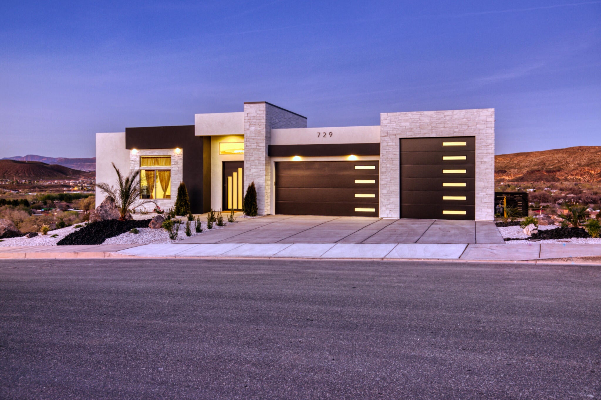 Contemporary stucco exterior with dark accents and stone-clad features