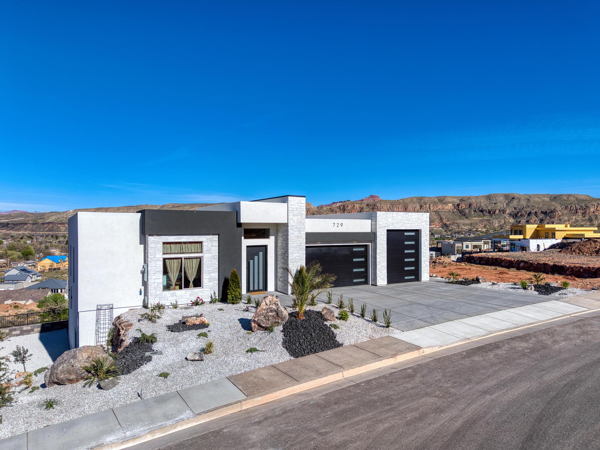 Modern facade featuring white stucco and stone accents