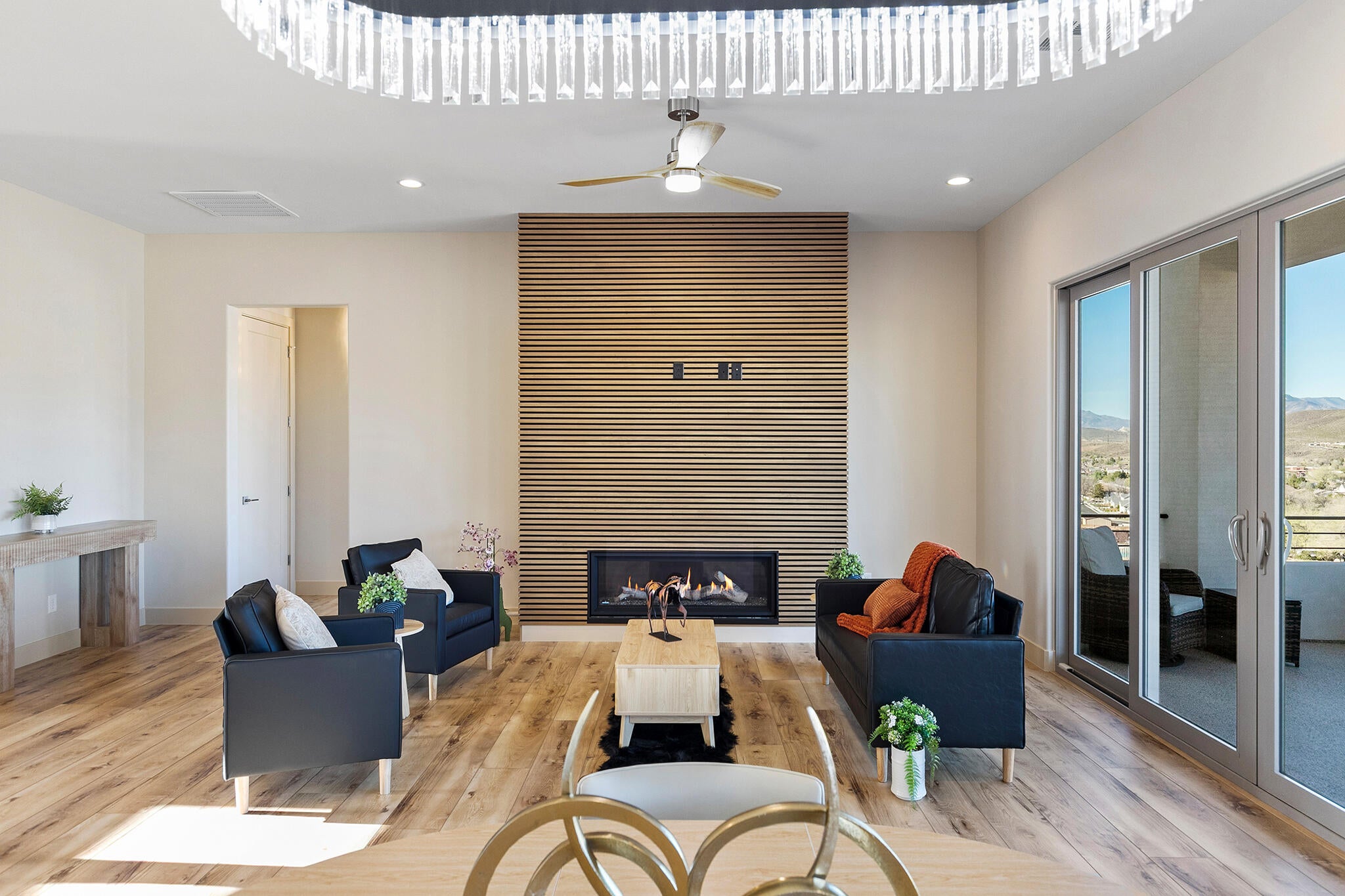 Spacious living area featuring wood-finish flooring and an accent wall with a built-in fireplace