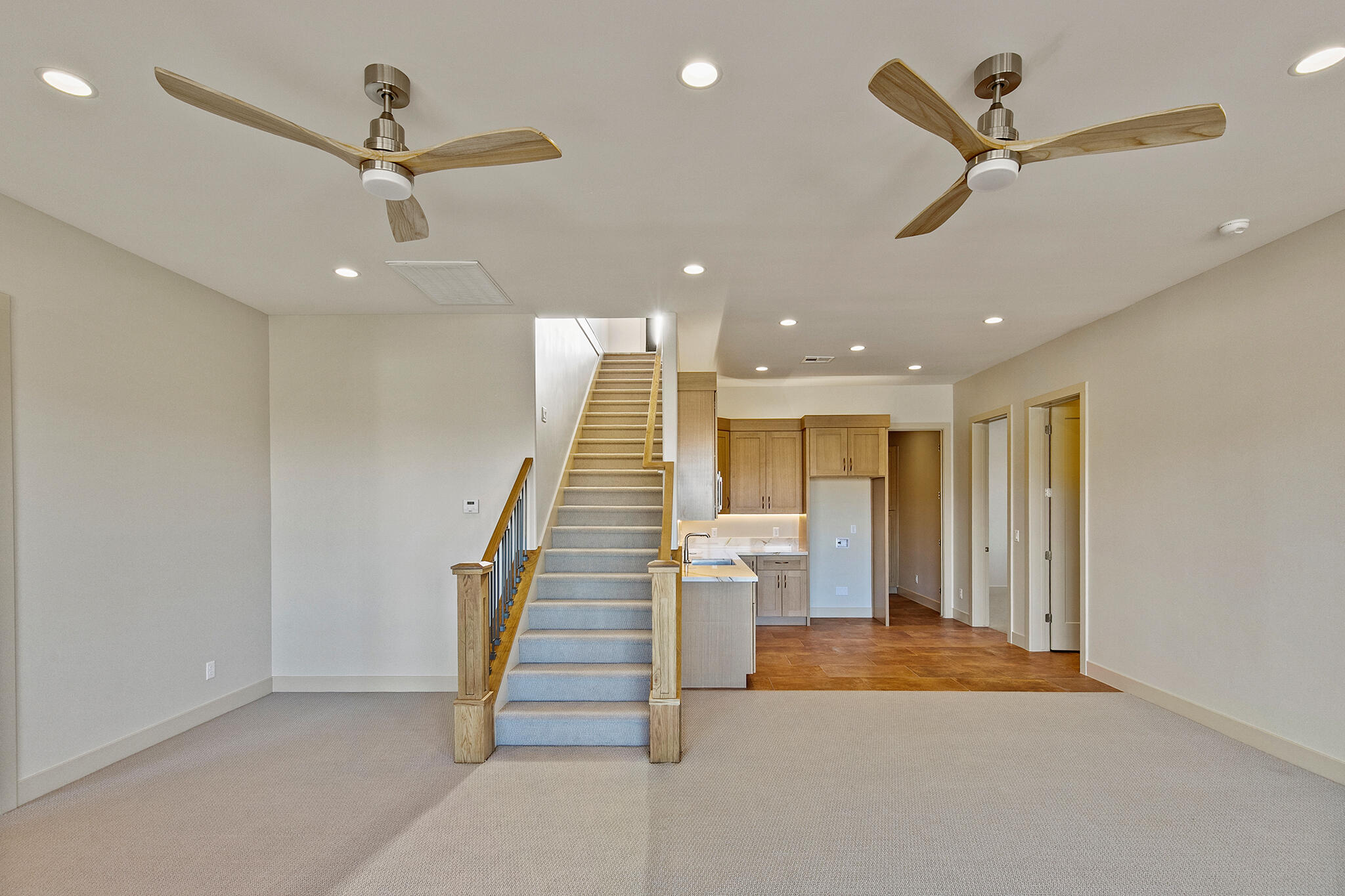 Open-concept living space featuring recessed lighting and two ceiling fans with integrated lighting