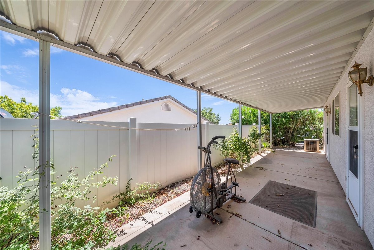 Covered patio with a concrete slab, exterior lighting fixtures, and direct access to the interior