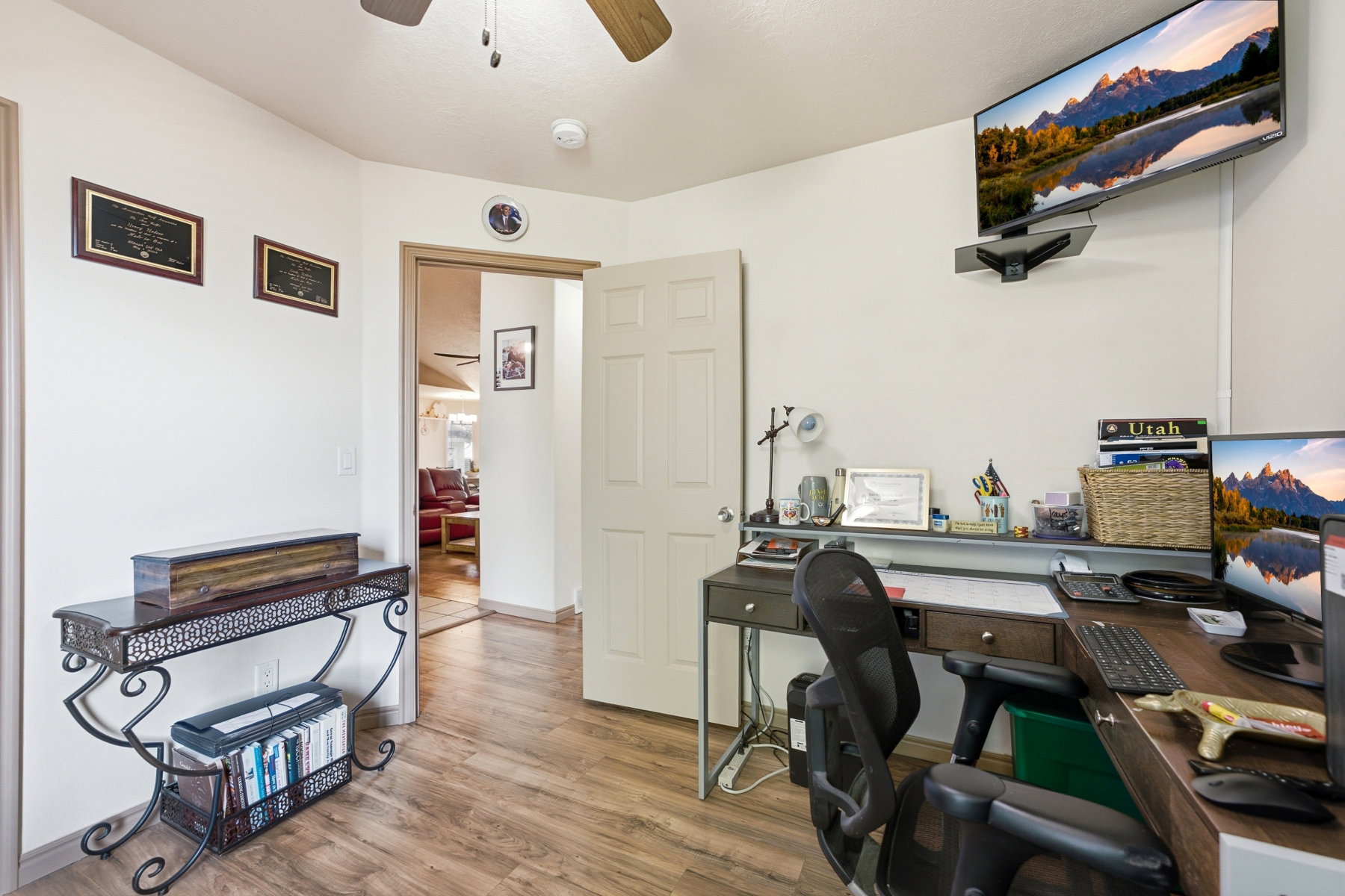 Wood-finish flooring throughout, with a ceiling fan and recessed lighting