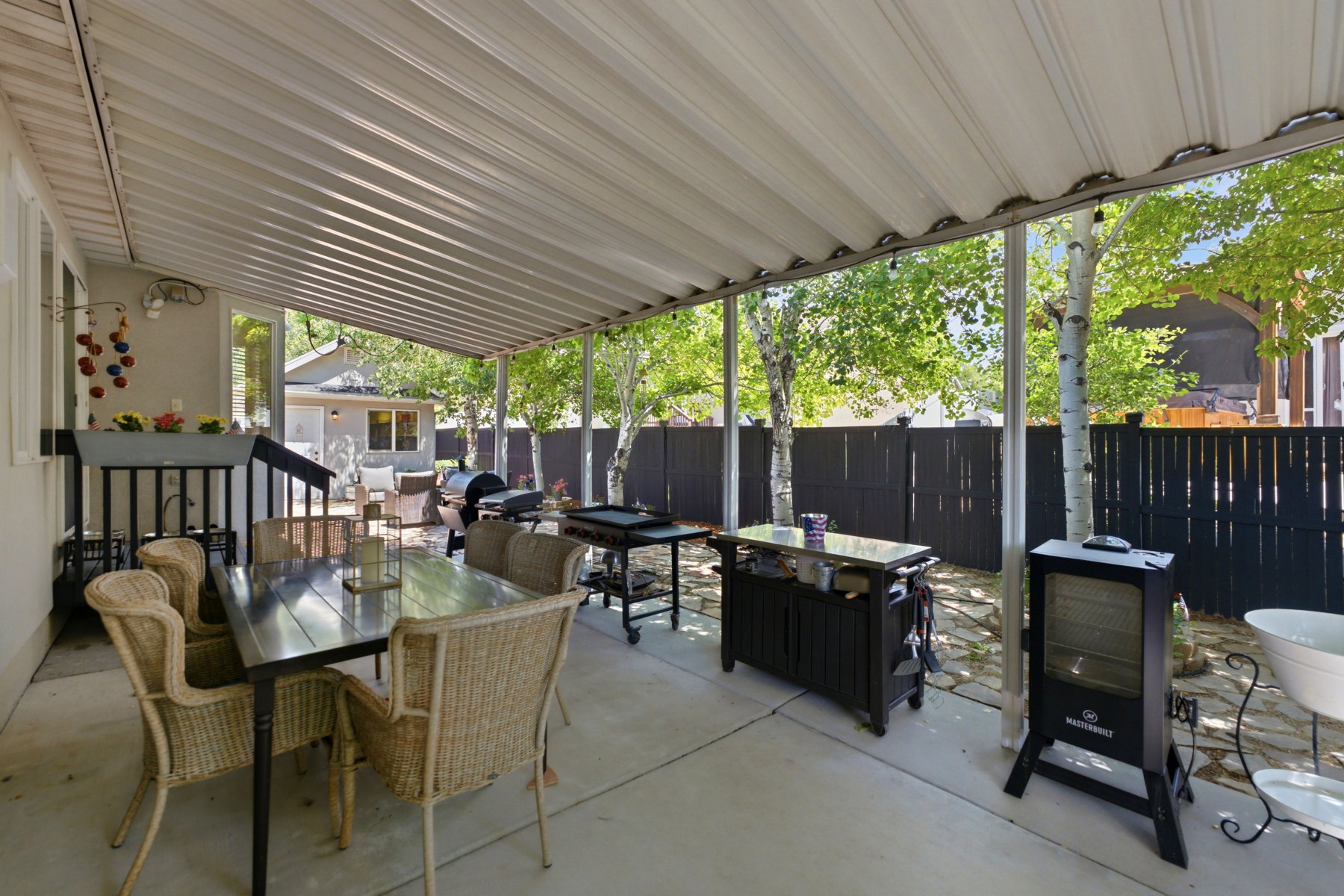Covered patio featuring concrete flooring and a solid roof structure