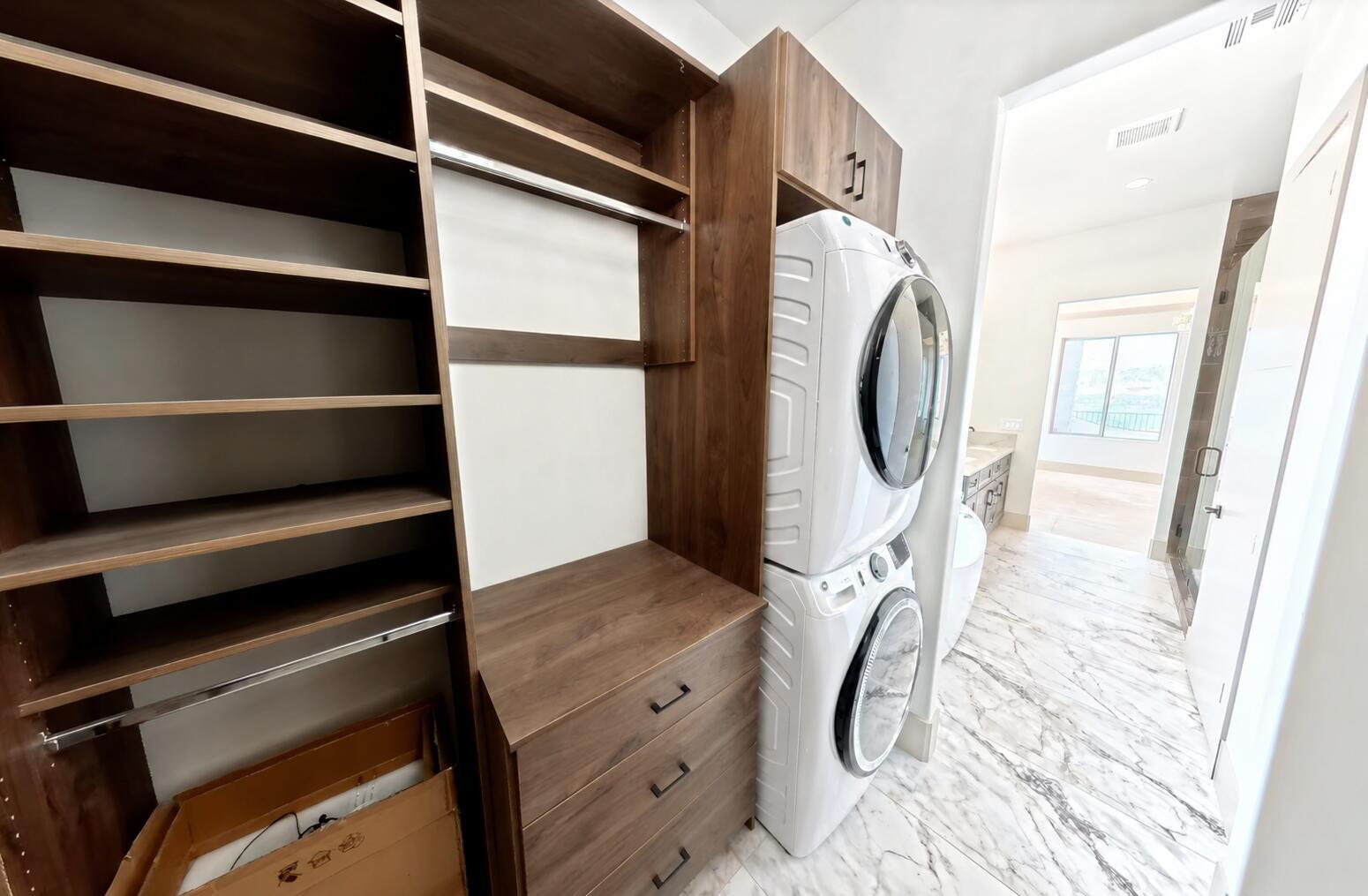 Custom wood-finish cabinetry and shelving with integrated hanging rods