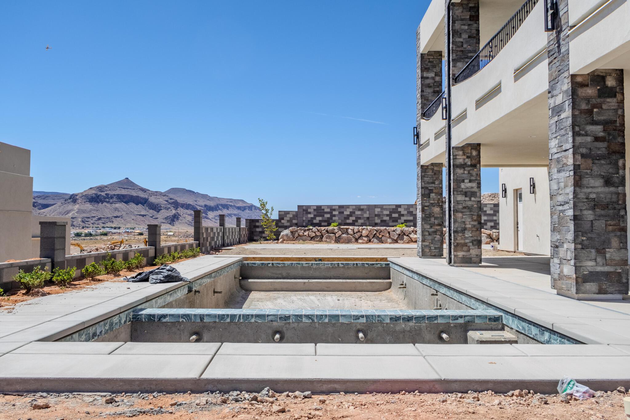 Unfinished pool structure featuring blue tile accents and integrated steps