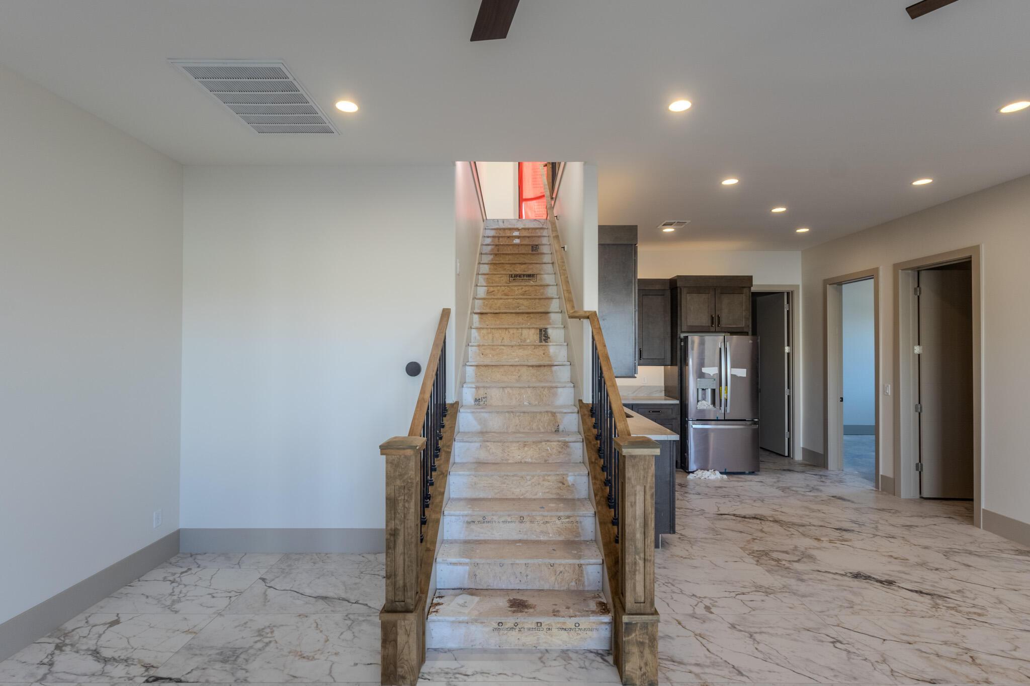 Grand staircase with wood newel posts and metal balusters