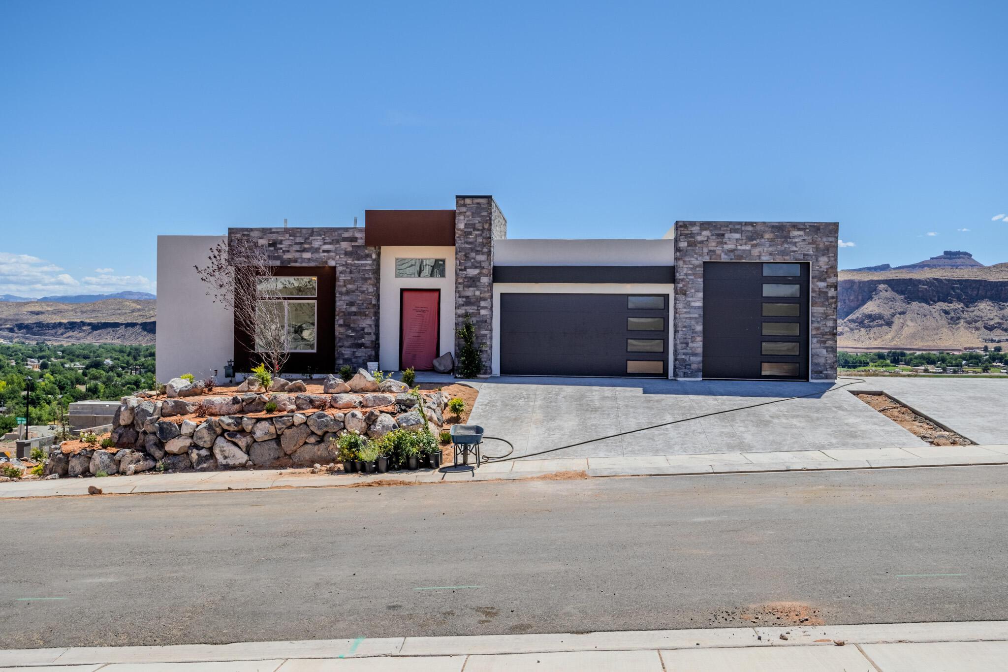 Modern architectural exterior featuring stone veneer accents and a smooth stucco finish