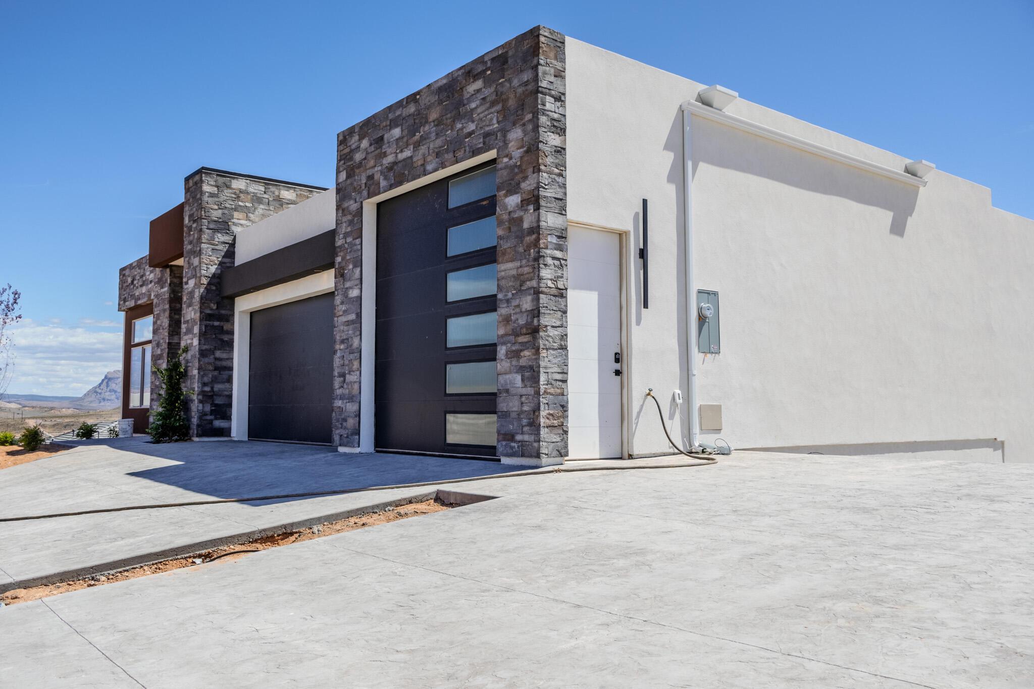 Modern exterior featuring stone veneer accents and stucco siding