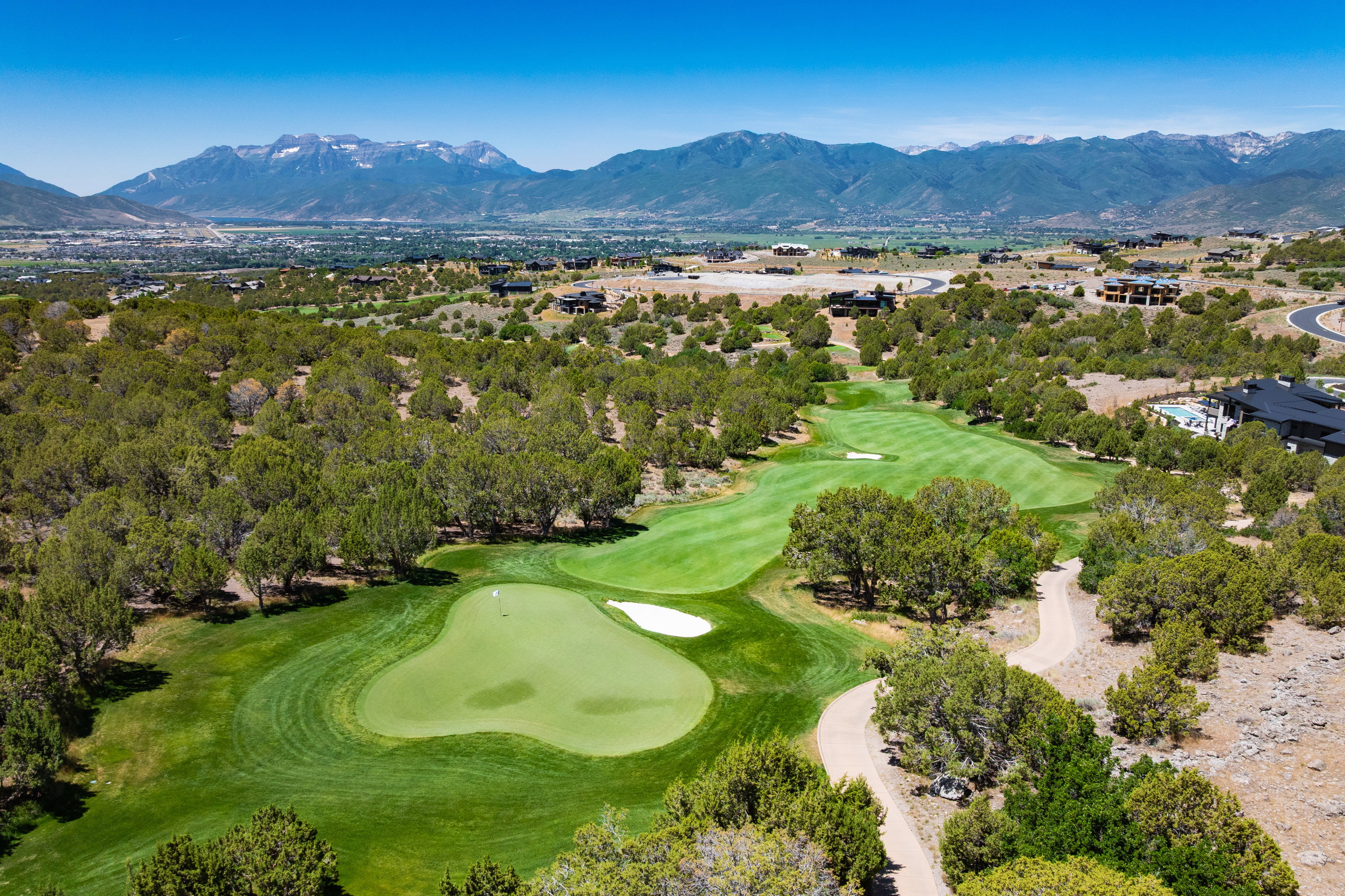 Expansive golf course setting featuring manicured greens and fairways