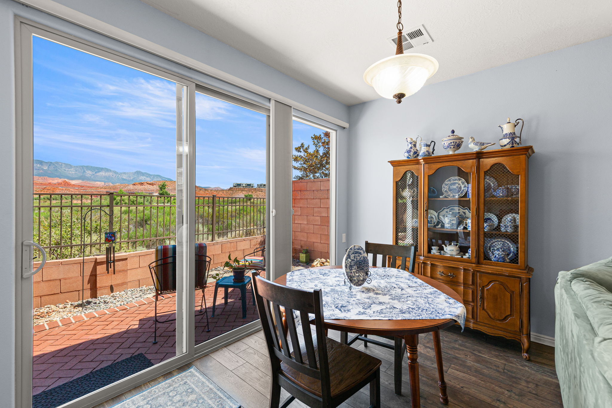 Sliding glass doors opening to a brick paver patio
