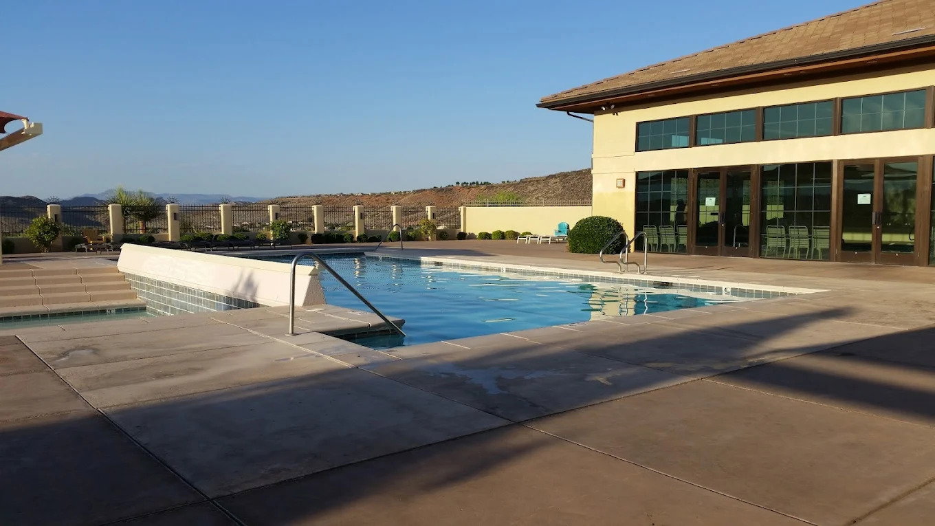 Community swimming pool with surrounding concrete decking