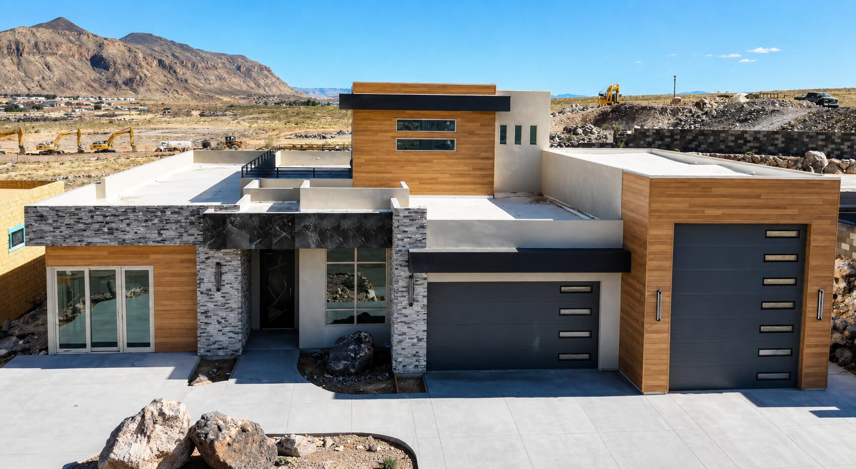 Modern exterior architecture featuring a flat roofline, wood-finish paneling, and stacked stone accents