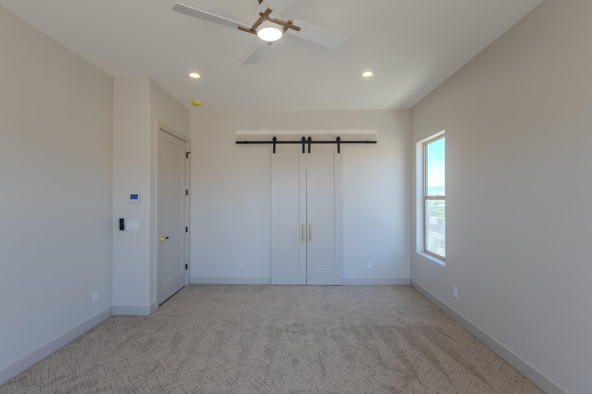 Bedroom featuring a ceiling fan with integrated lighting, recessed lighting, and patterned carpeting