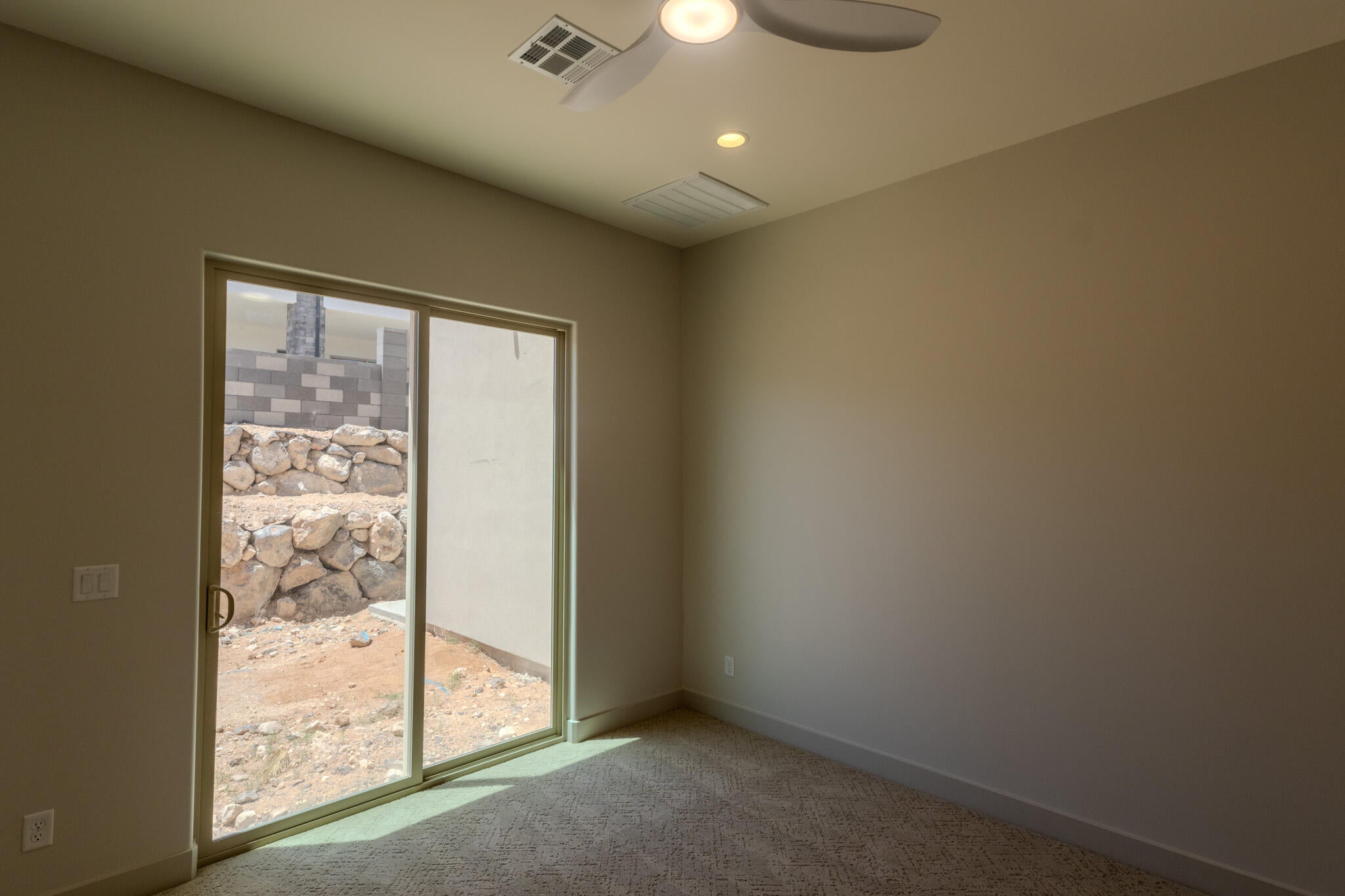 Room featuring beige carpet and neutral painted walls