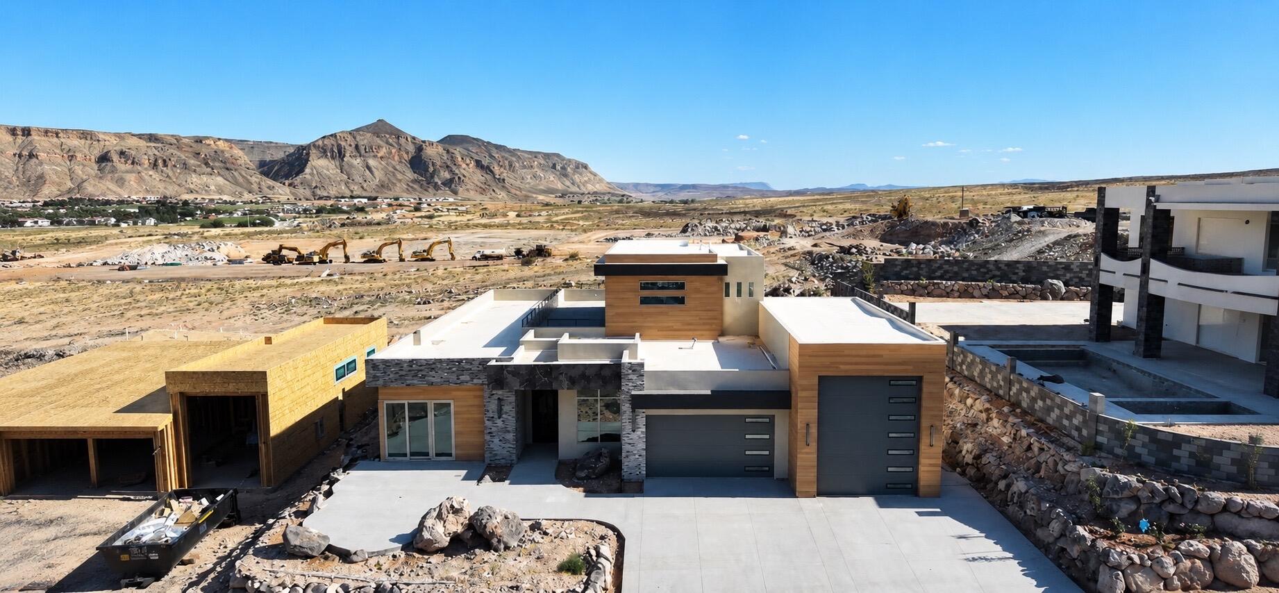 Contemporary exterior featuring a flat roofline, stone veneer accents, and wood-finish siding
