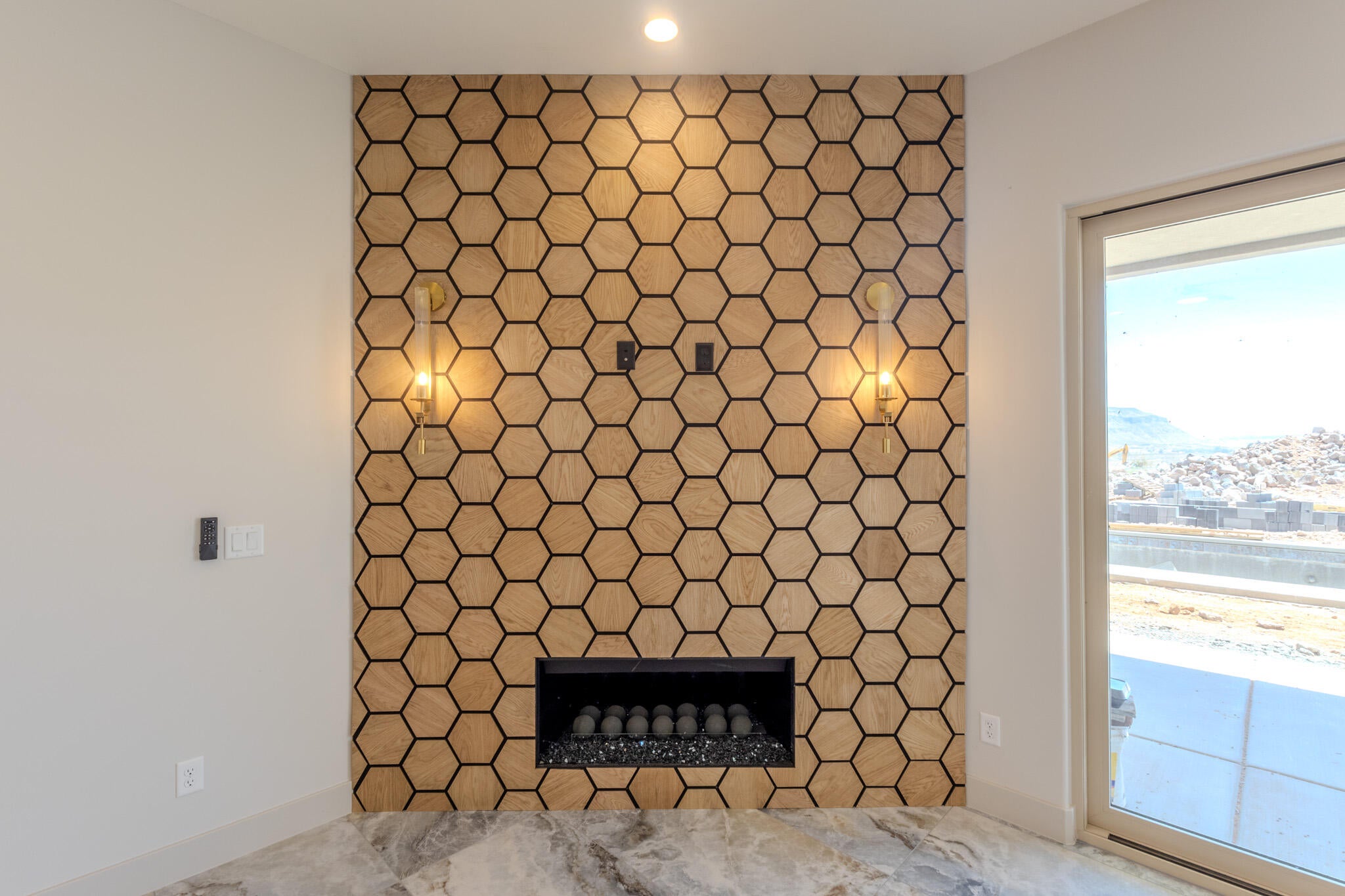 Contemporary fireplace featuring a hexagonal wood-finish tile surround and a built-in electric firebox