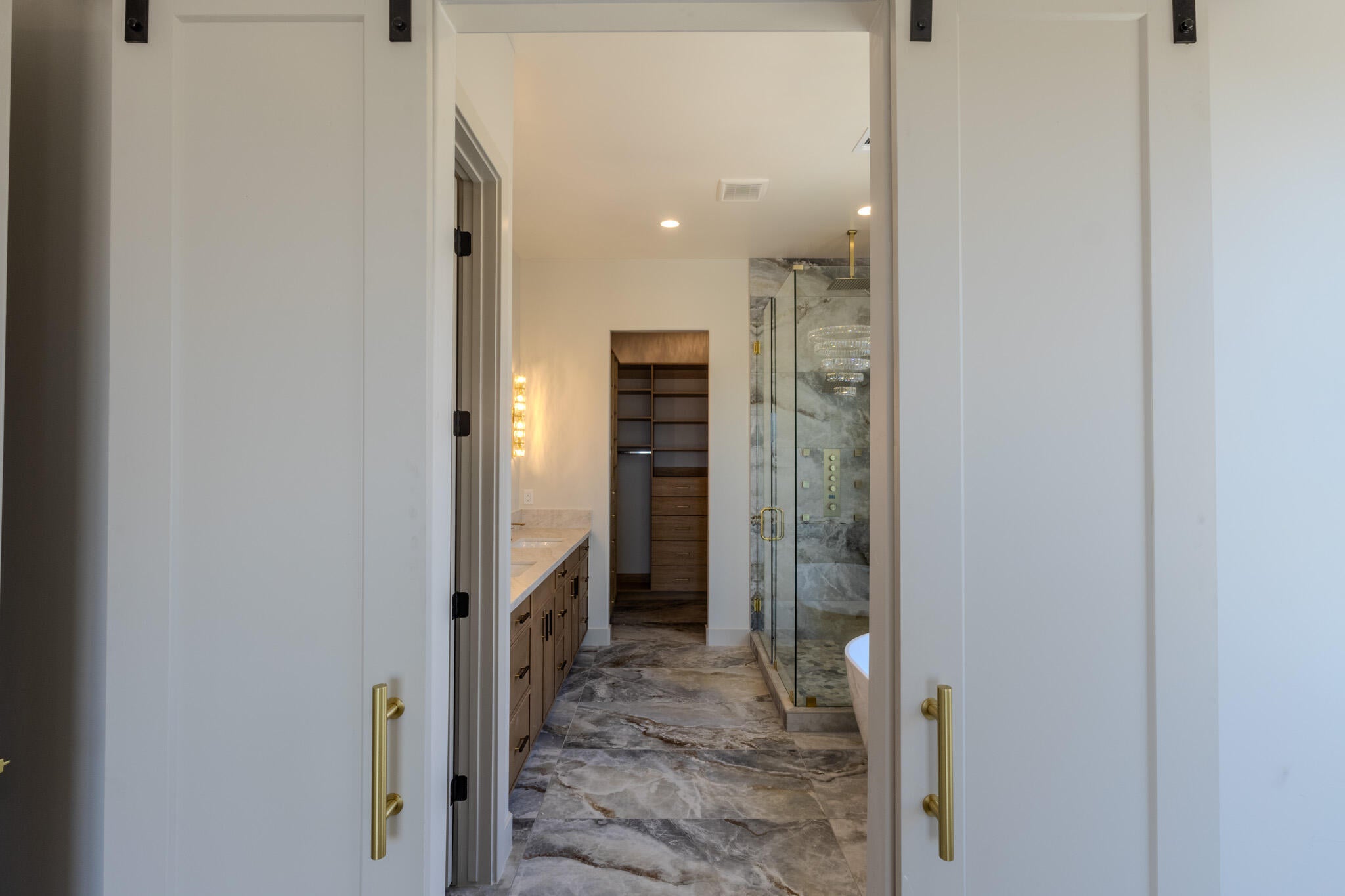 Sliding barn doors with black hardware and gold-finish pulls