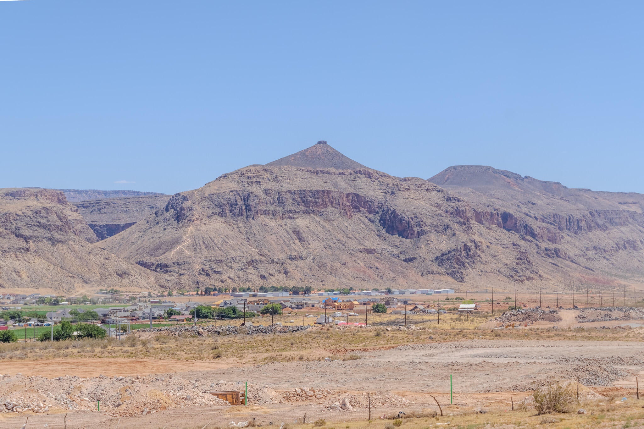 Expansive mountain range backdrop with a broad, arid foreground