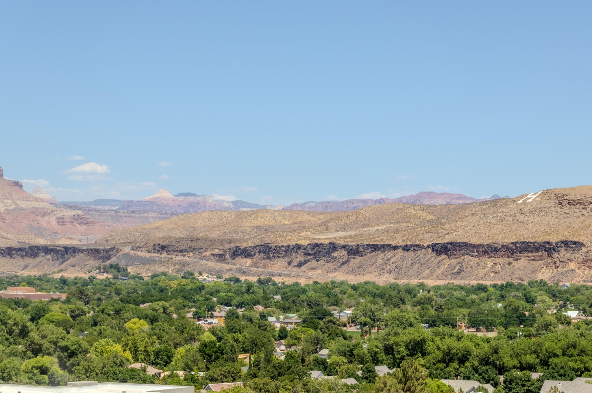 Expansive desert landscape with distant mountains under a clear sky