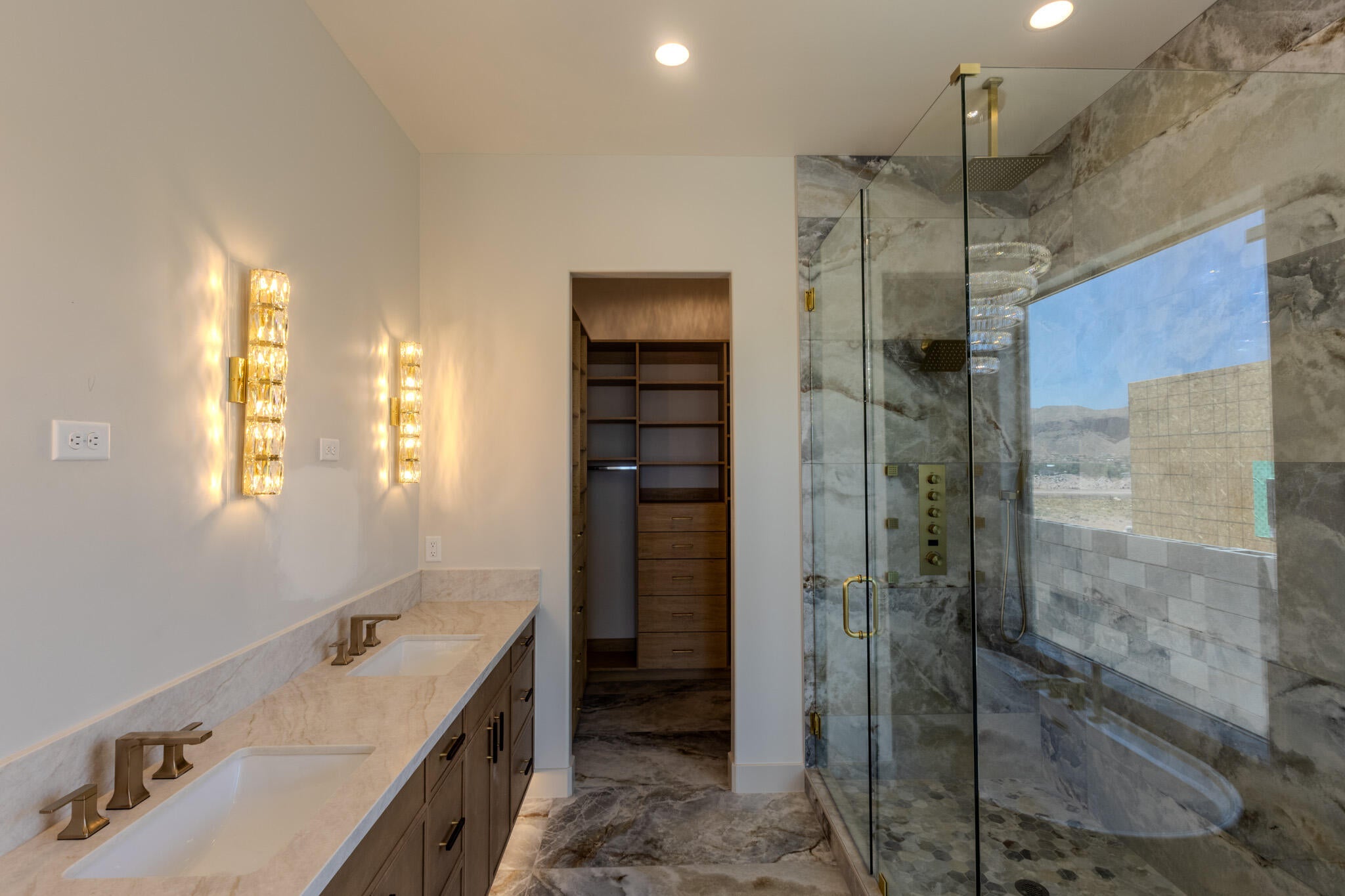 Dual vanity with undermount sinks, bronze faucets, and a light-toned countertop