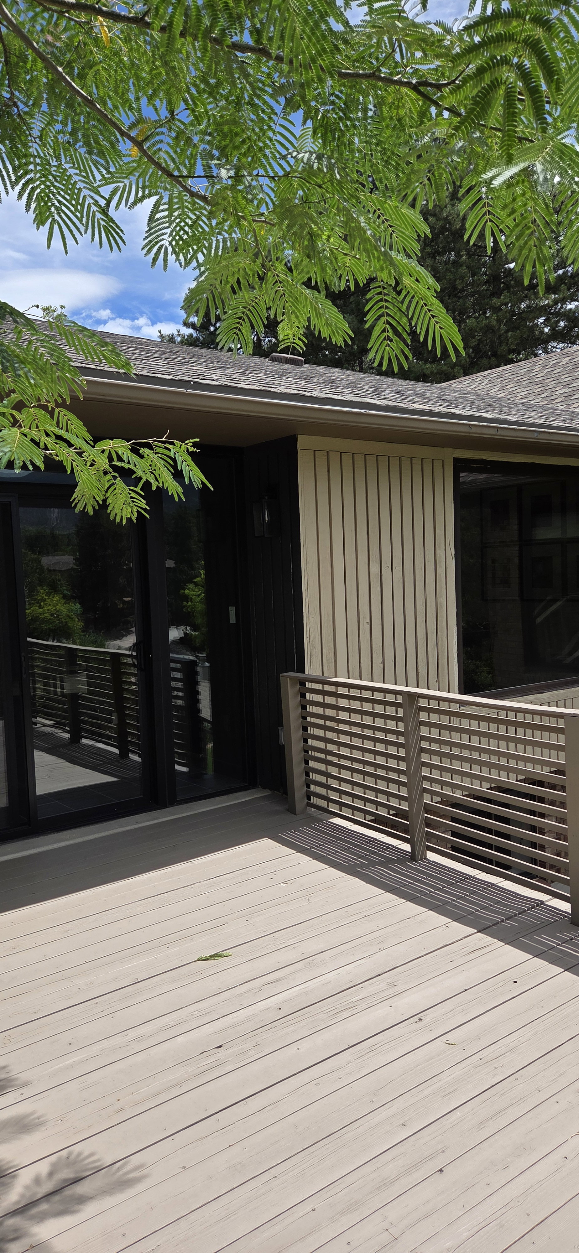 Spacious exterior deck with composite decking and horizontal railing