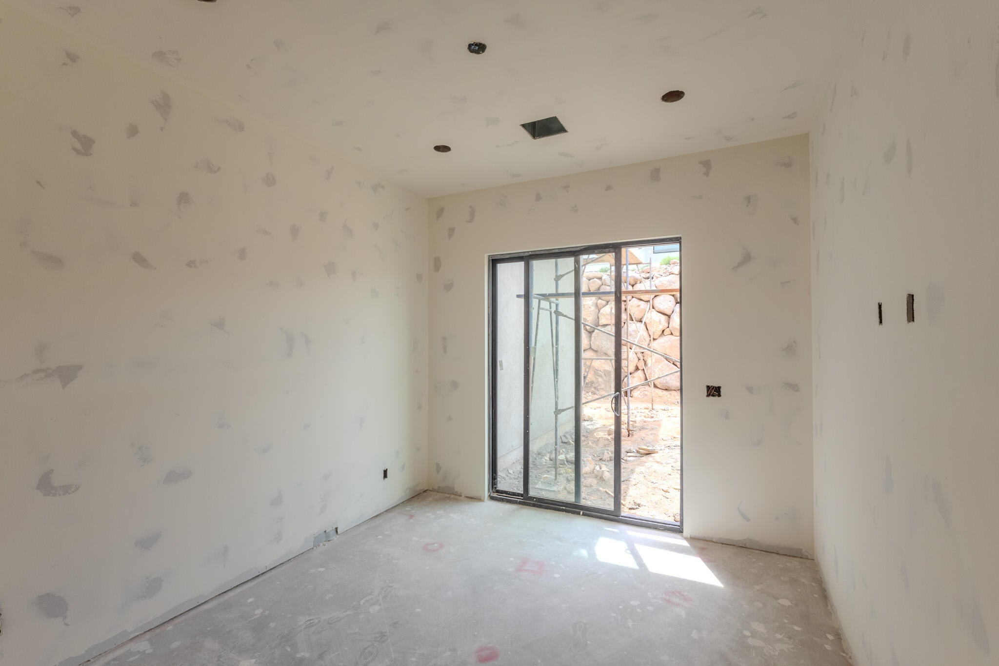 Interior space featuring a sliding glass door, recessed lighting, and a concrete floor