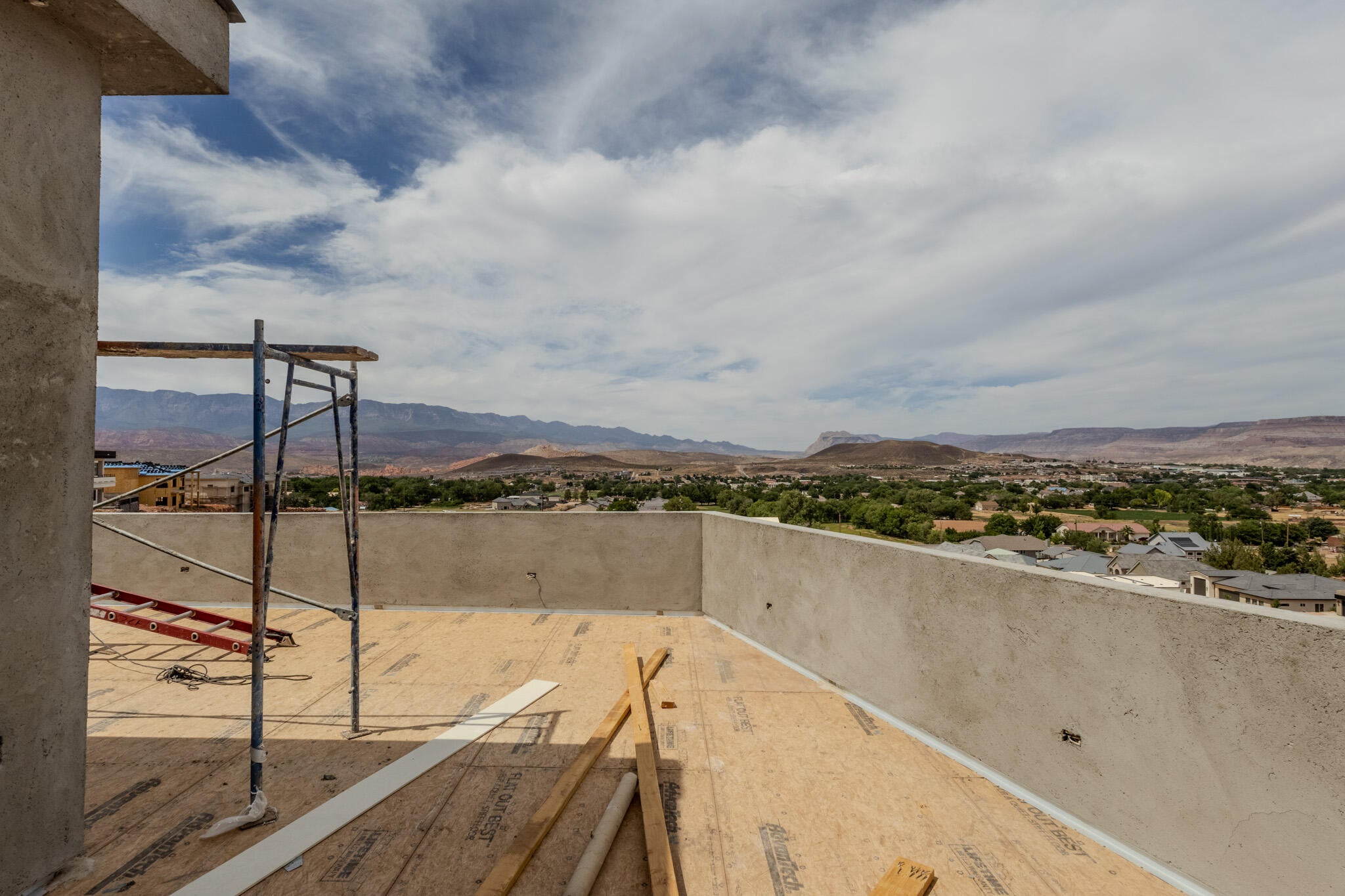 Rooftop deck featuring a concrete perimeter wall and expansive mountain and valley scenery