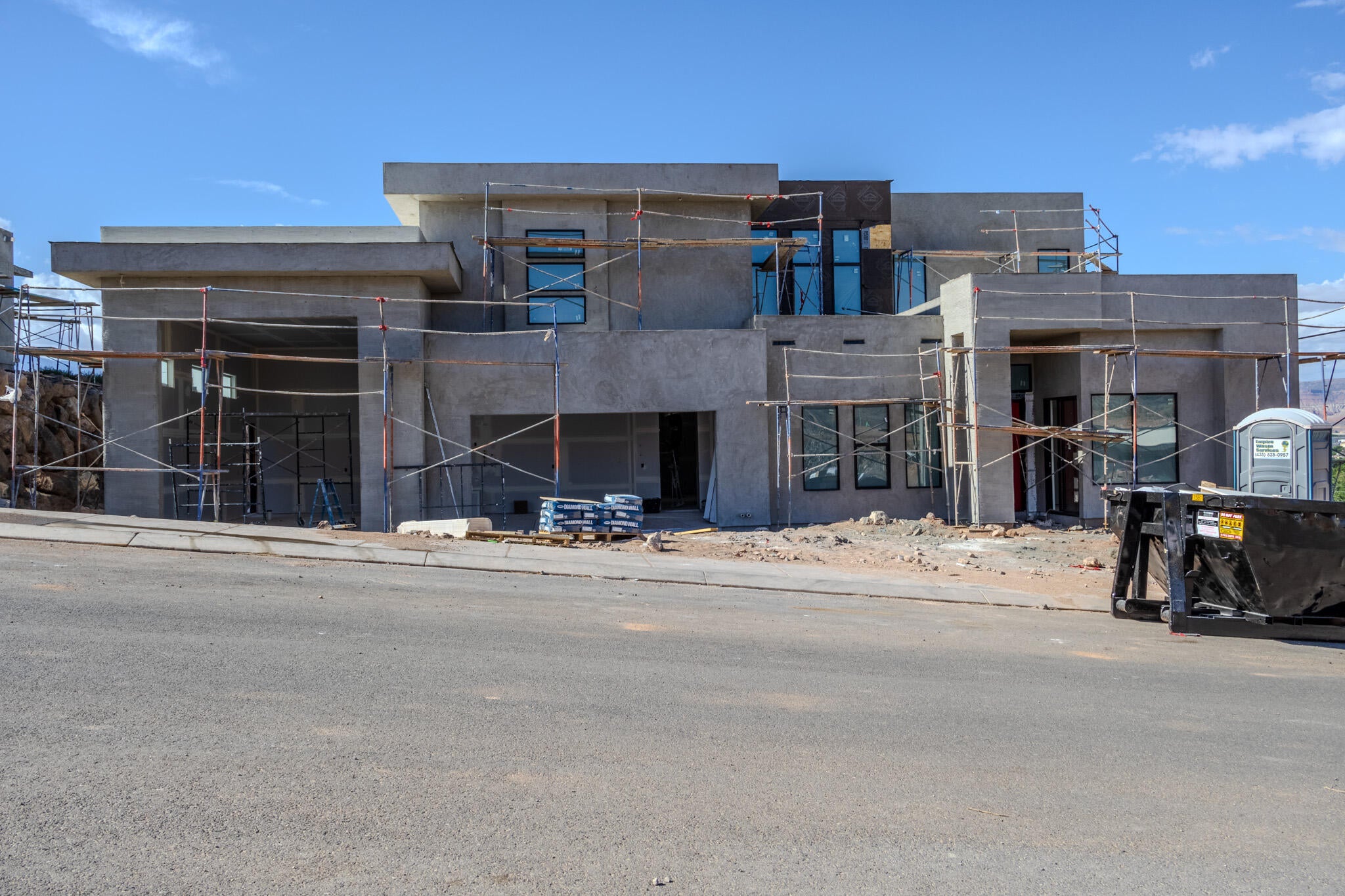 Contemporary architectural style featuring a stucco exterior finish and multi-level design