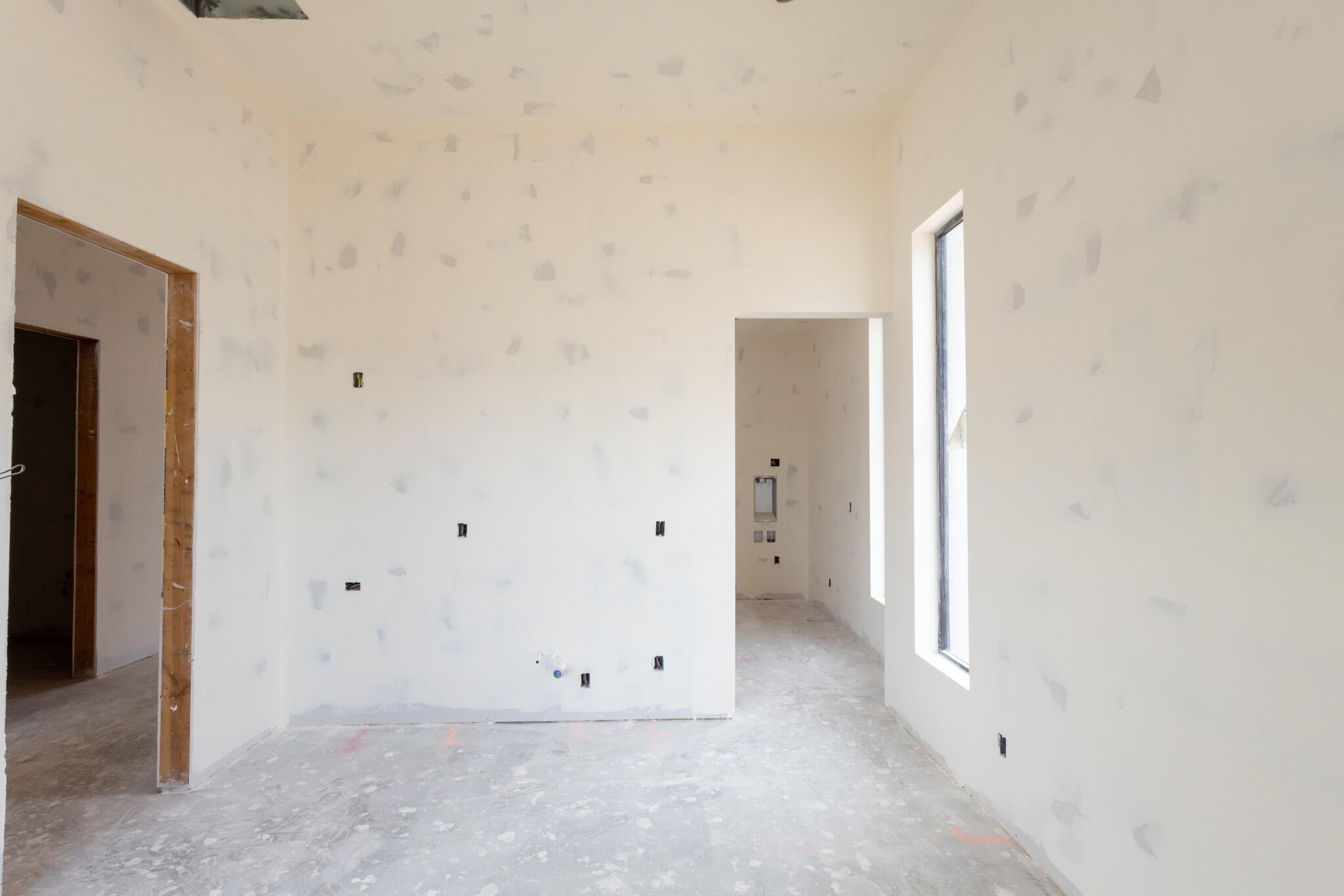 Spacious interior with drywall installation in progress