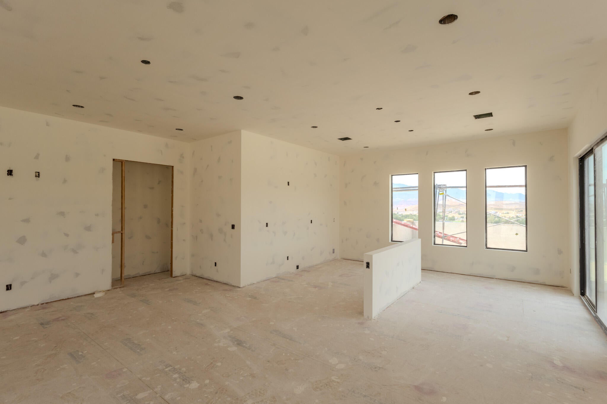 Spacious interior featuring multiple large windows and an expansive sliding glass door
