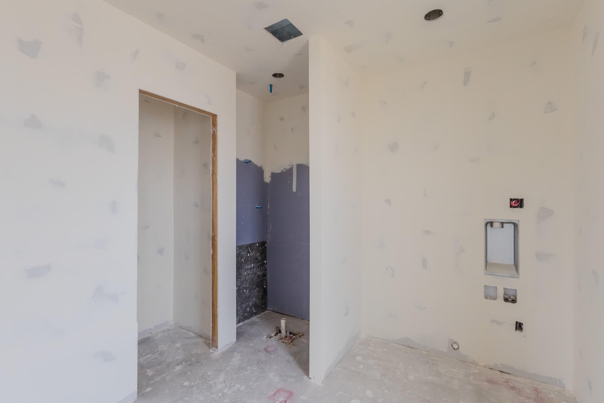 Utility area featuring drywall installation and plumbing rough-ins